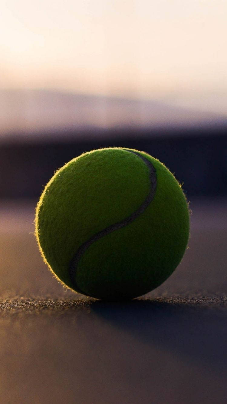 A Tennis Ball On A Tennis Court Background