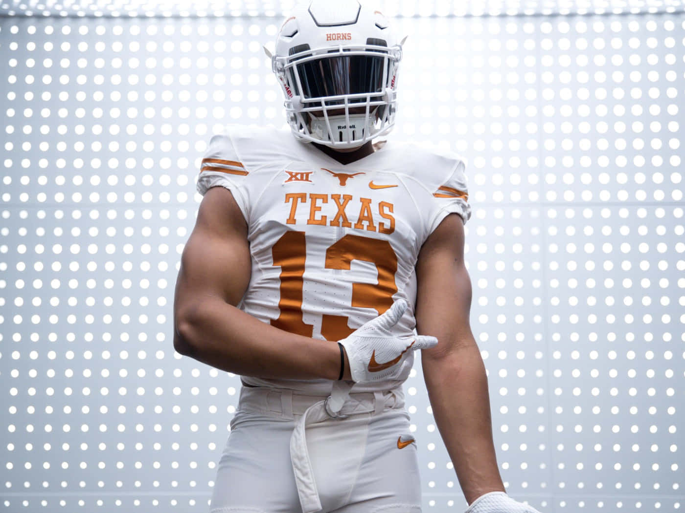 A Texas Football Player In A Uniform Background