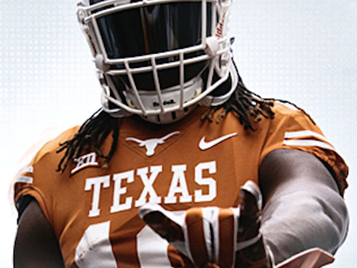 A Texas Football Player Is Holding A Football Background