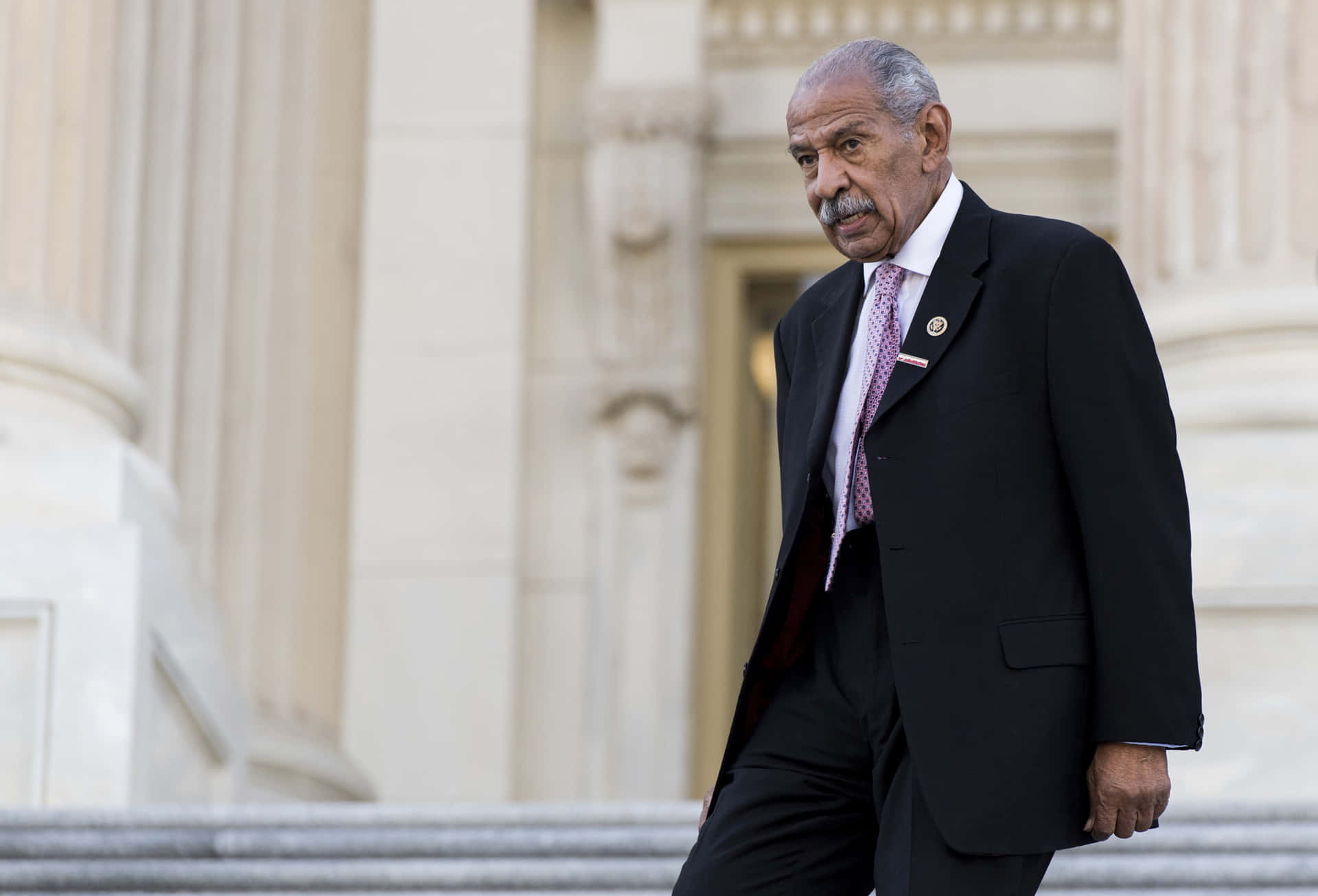 A Thought-provoking Image Of John Conyers In A Political Discussion Background