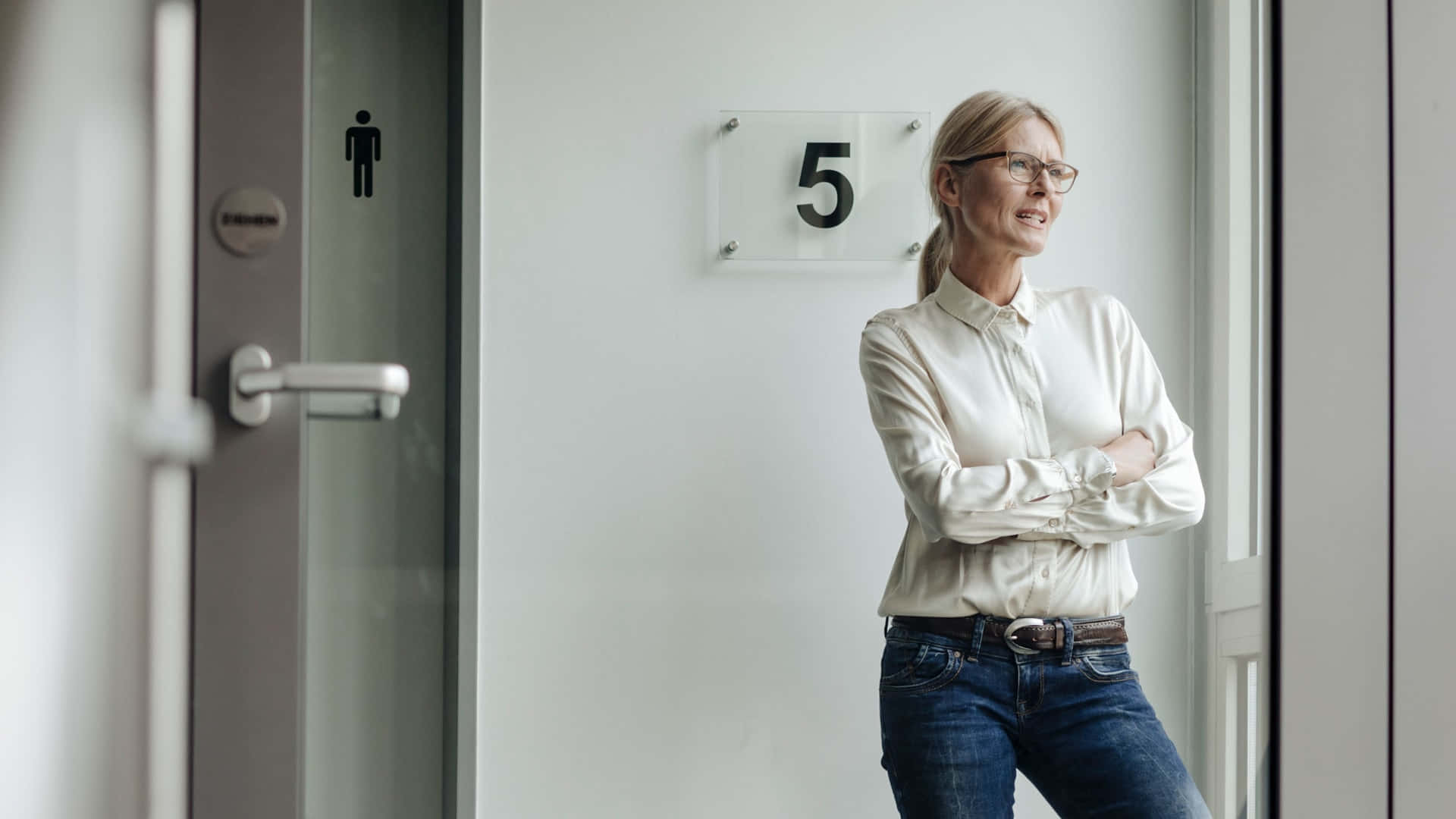 A Thoughtful Middle-aged Woman In Stylish Eyeglasses