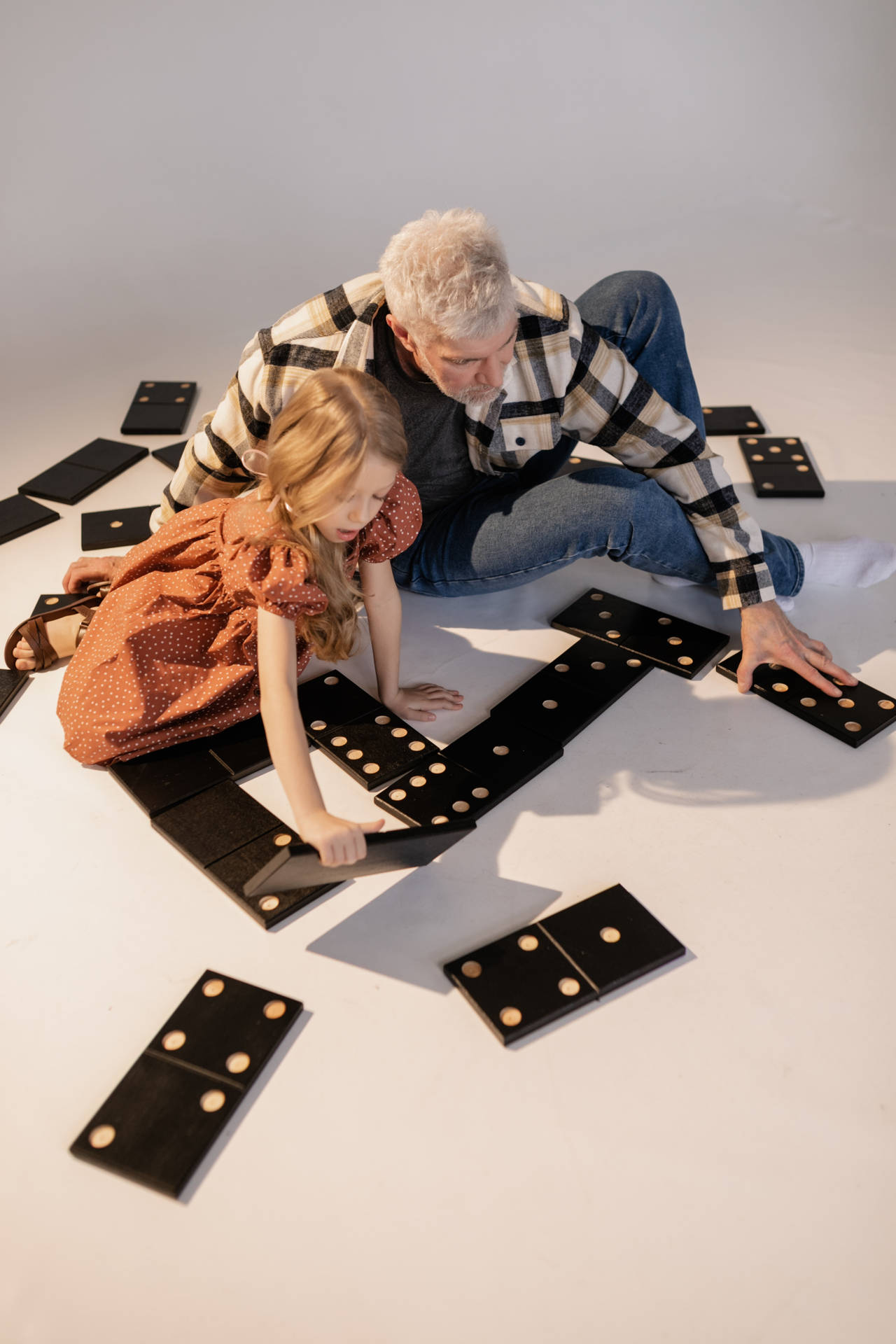 A Thoughtful Process Of Arranging Giant Dominos Background