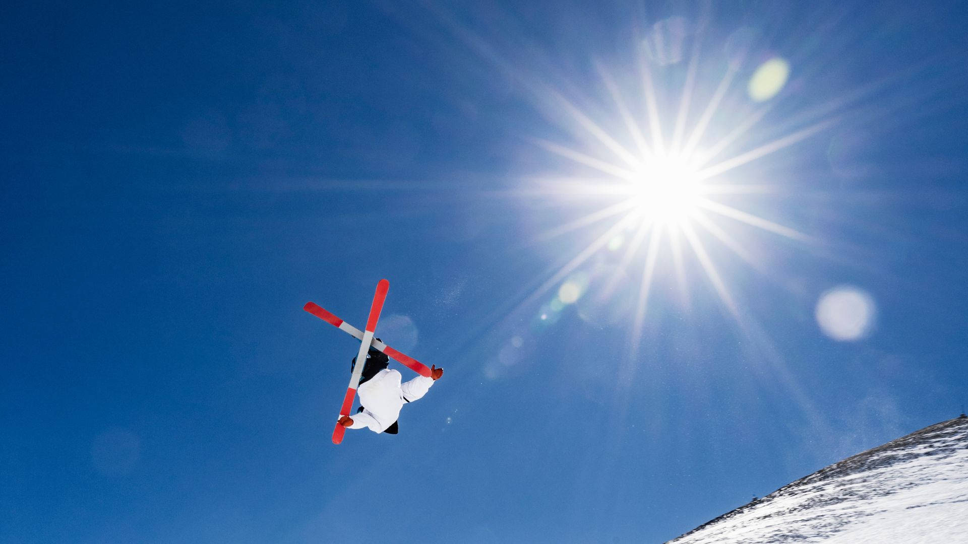 A Thrilling Mid-air Ski Jumping Moment Background