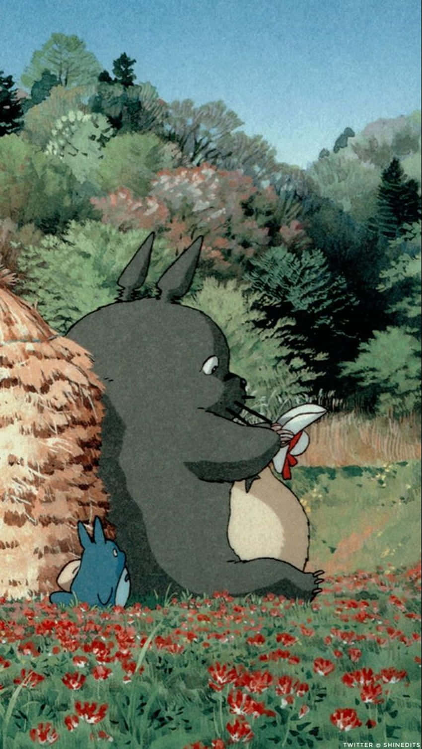 A Totoro And A Hay Bale Sitting In A Field