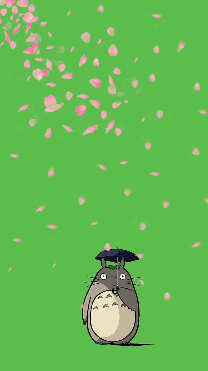 A Totoro With A Hat Flying In The Air Background