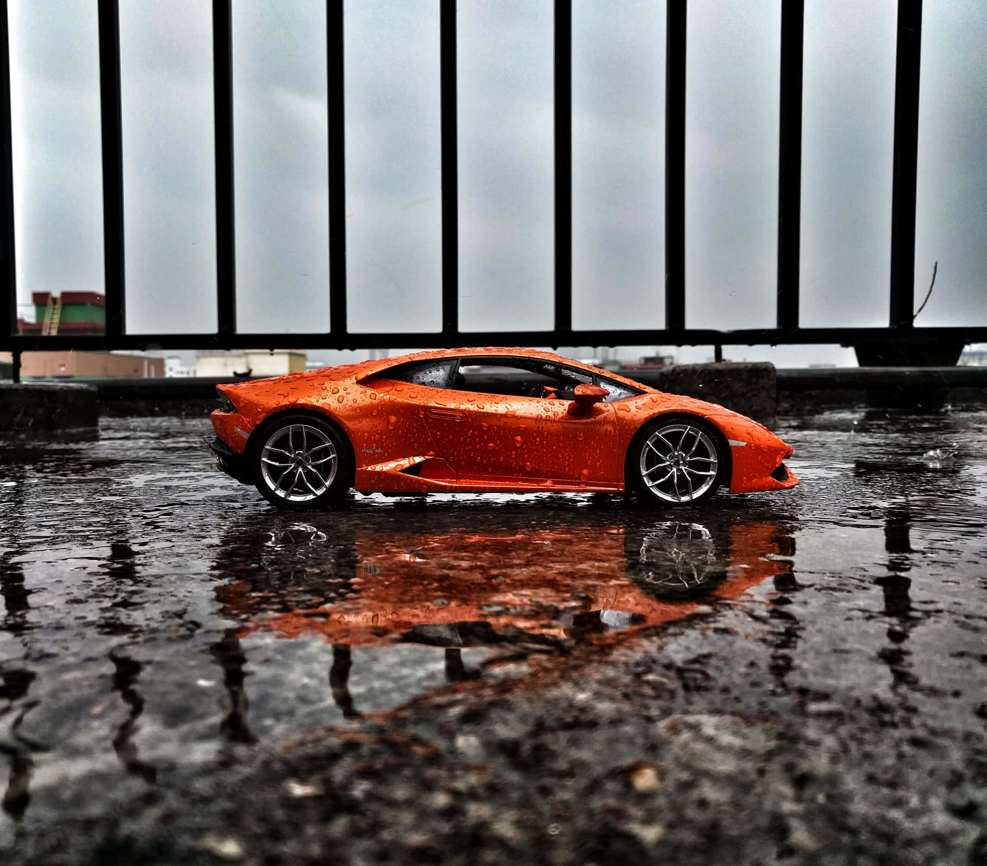 A Toy Car Is Sitting In A Puddle Of Water Background