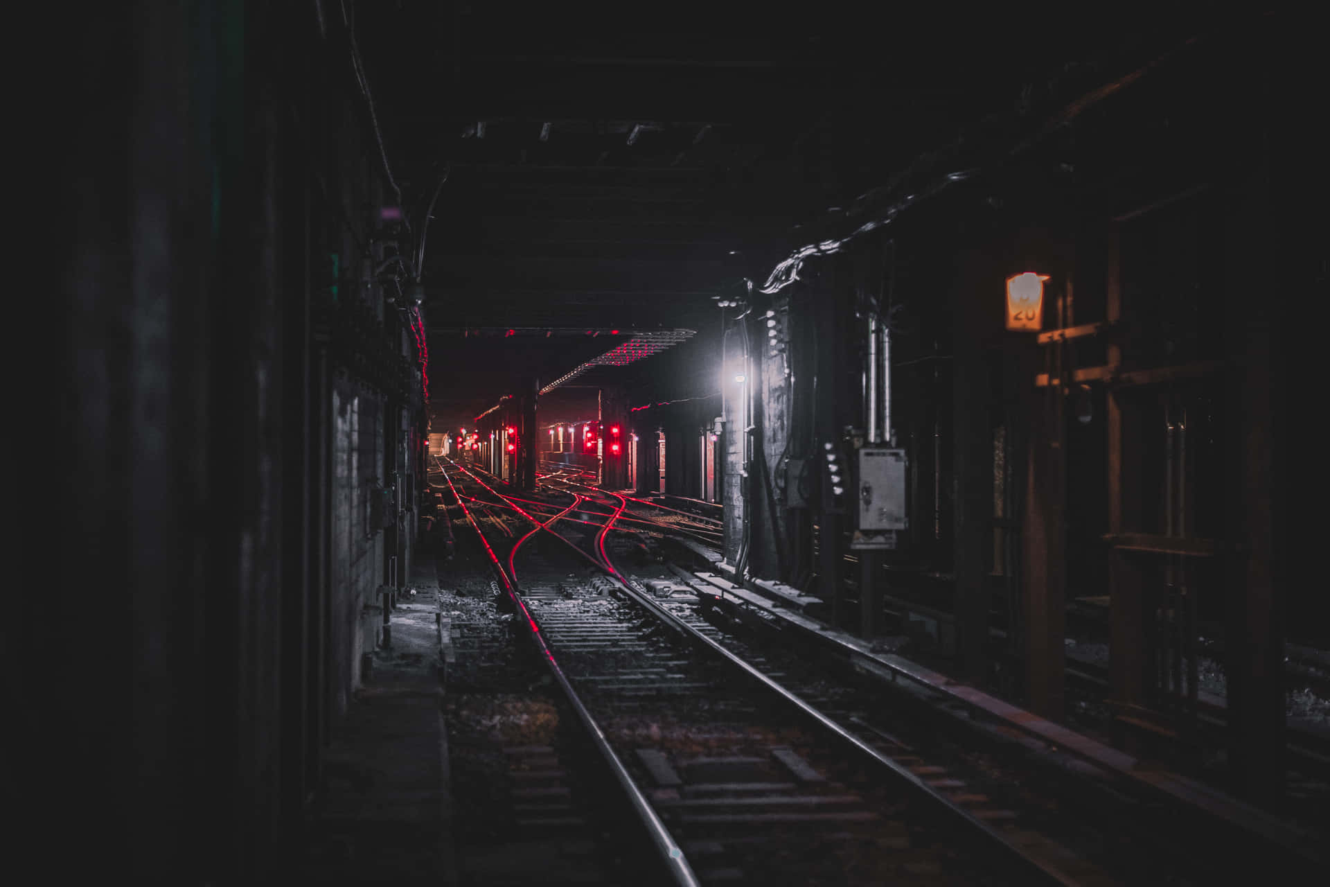 A Train Track In A Dark Tunnel Background