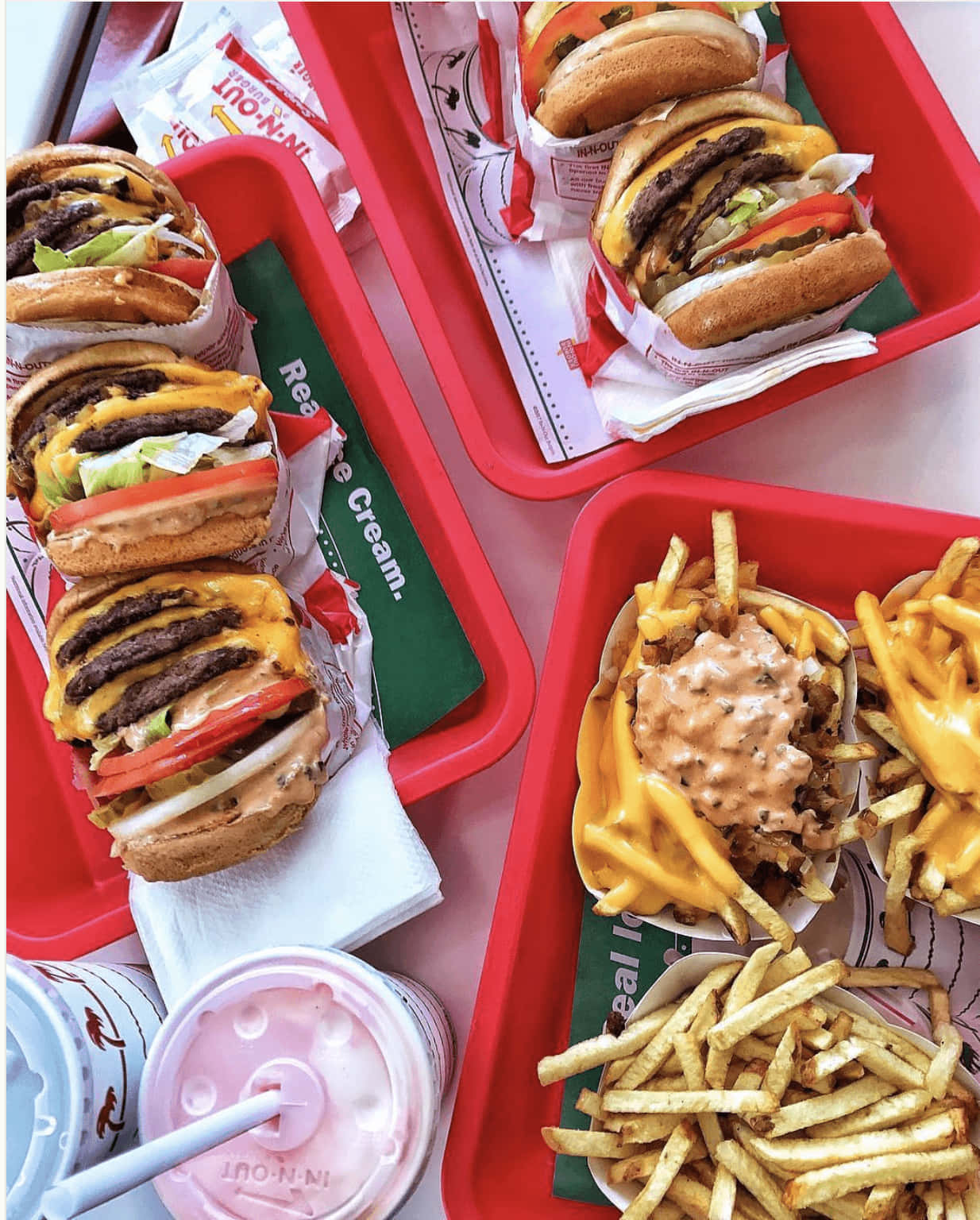 A Tray Of Food With Fries And A Burger Background