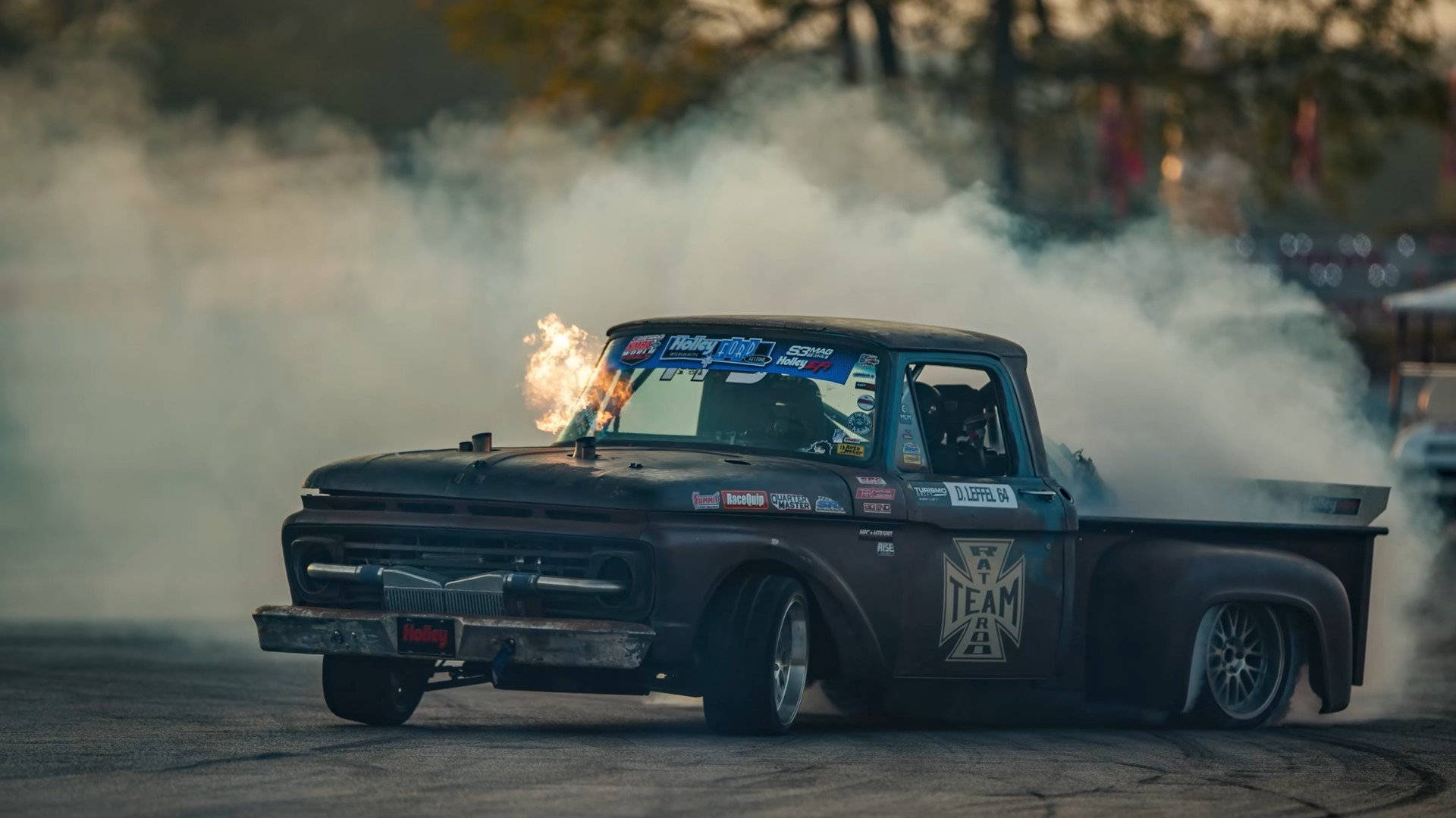 A Truck With Smoke Coming Out Of It Background