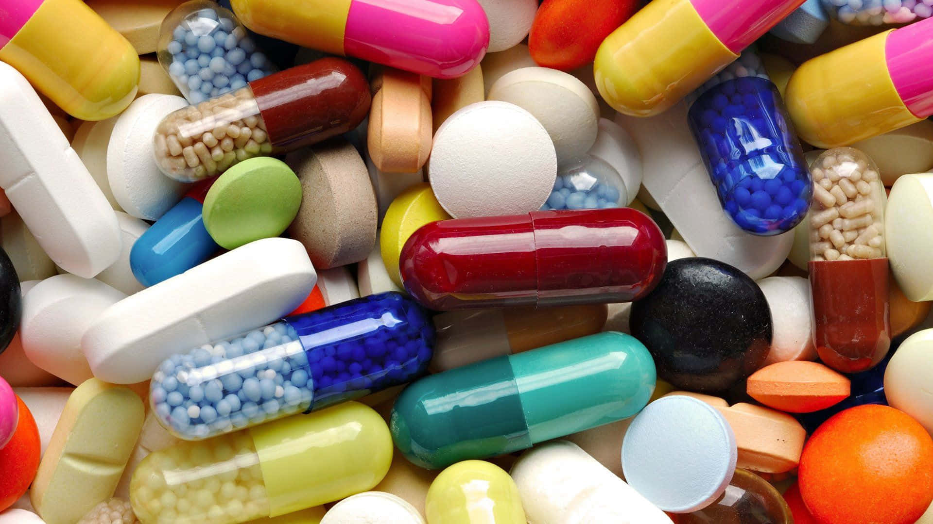 A Variety Of Assorted Medication Capsules And Tablets Background