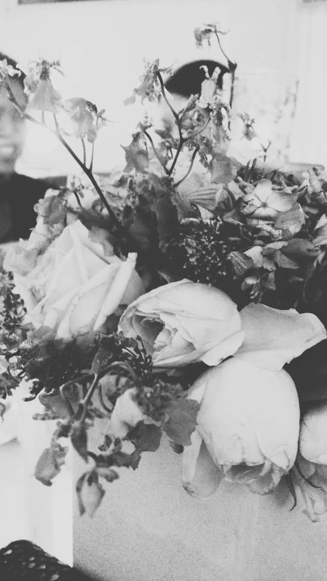 A Vase Of Flowers On A Table Background
