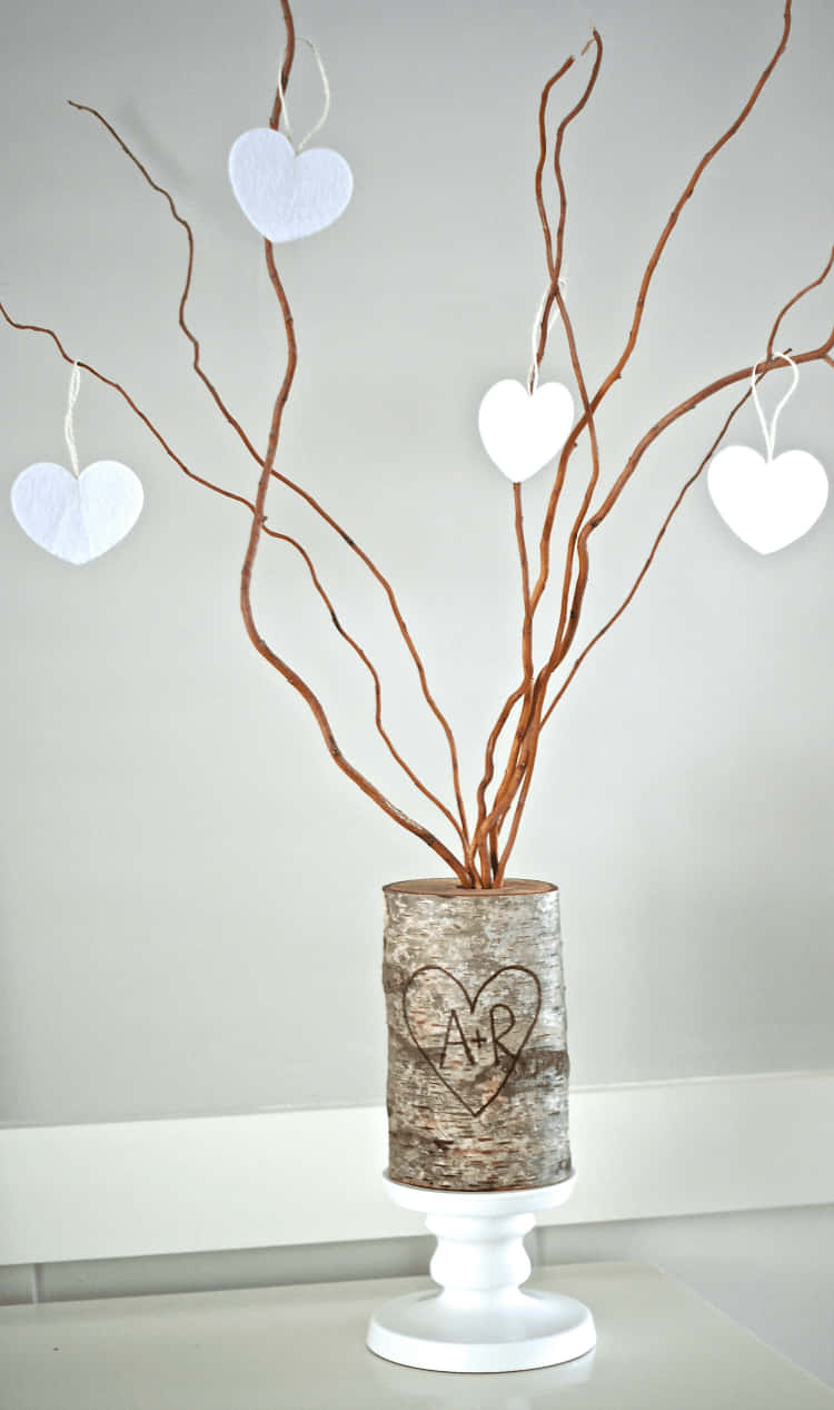 A Vase With Branches And Hearts On It Background