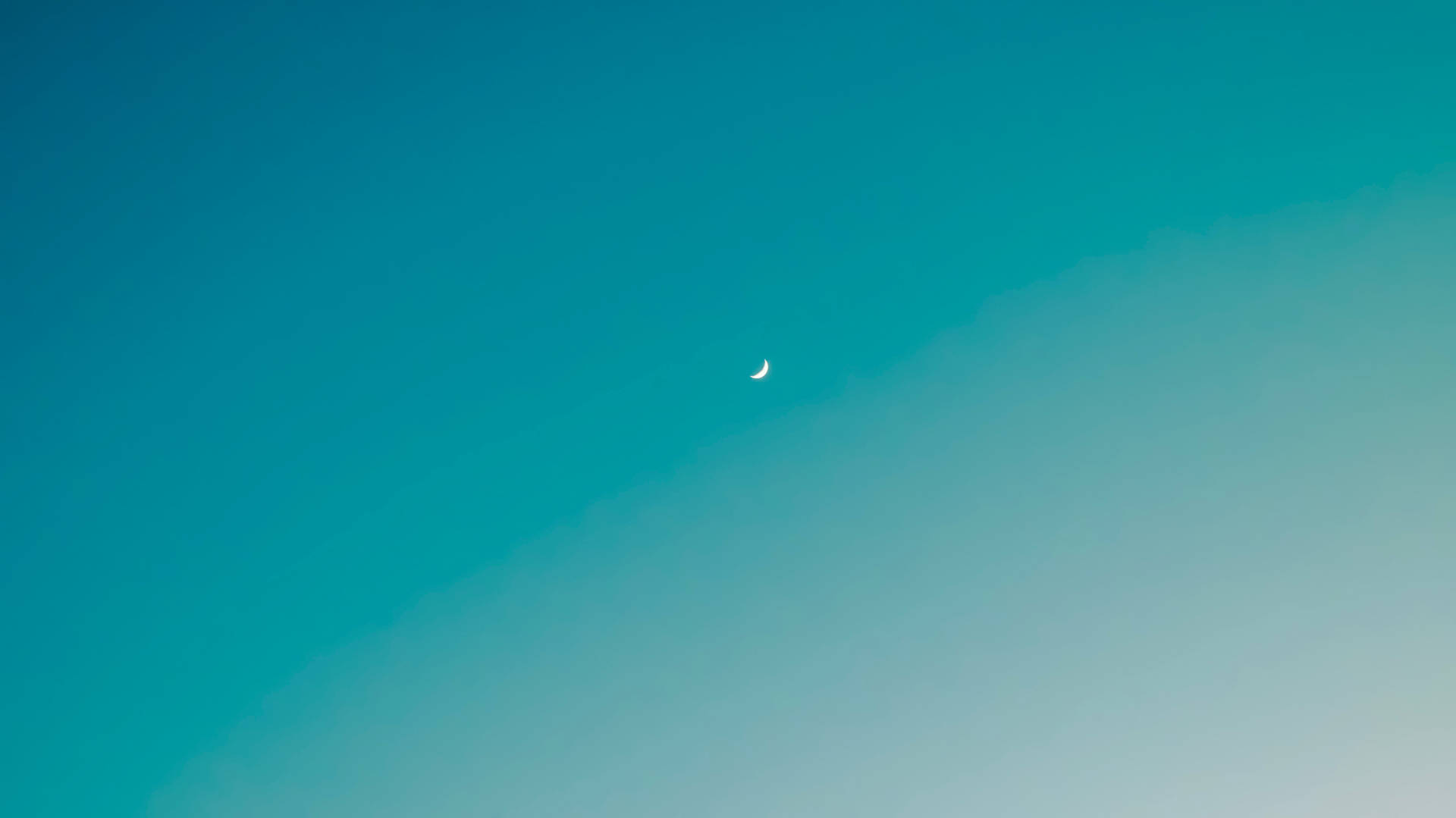 A Vibrant And Beautiful Ombre Sky Featuring A Crescent Moon Background