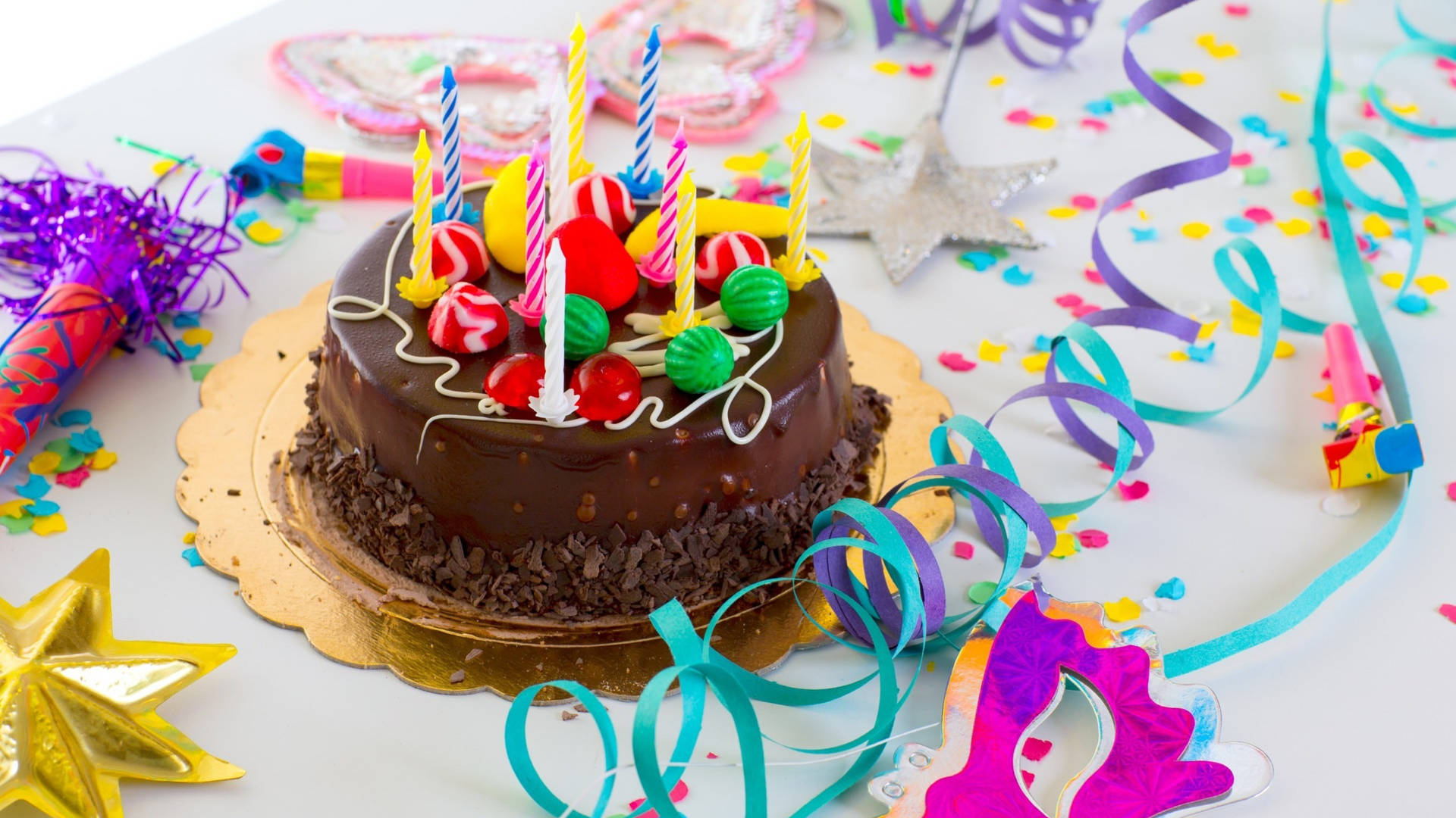 A Vibrant And Colorful Birthday Cake With Lit Candles Background