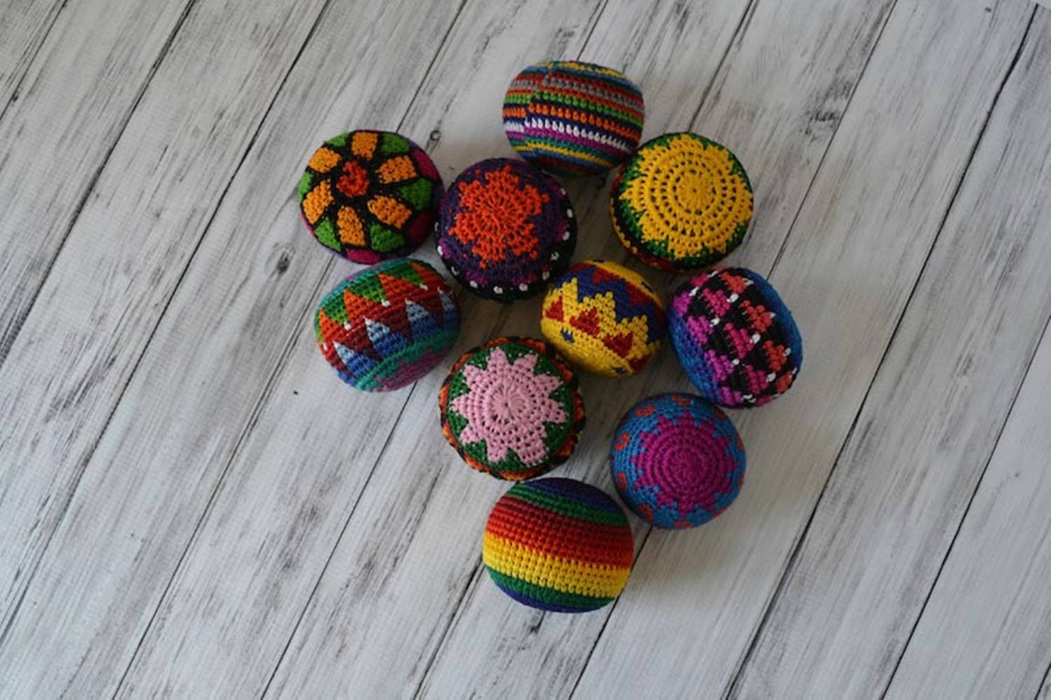 A Vibrant Crochet Hacky Sack In Dark Colors Background