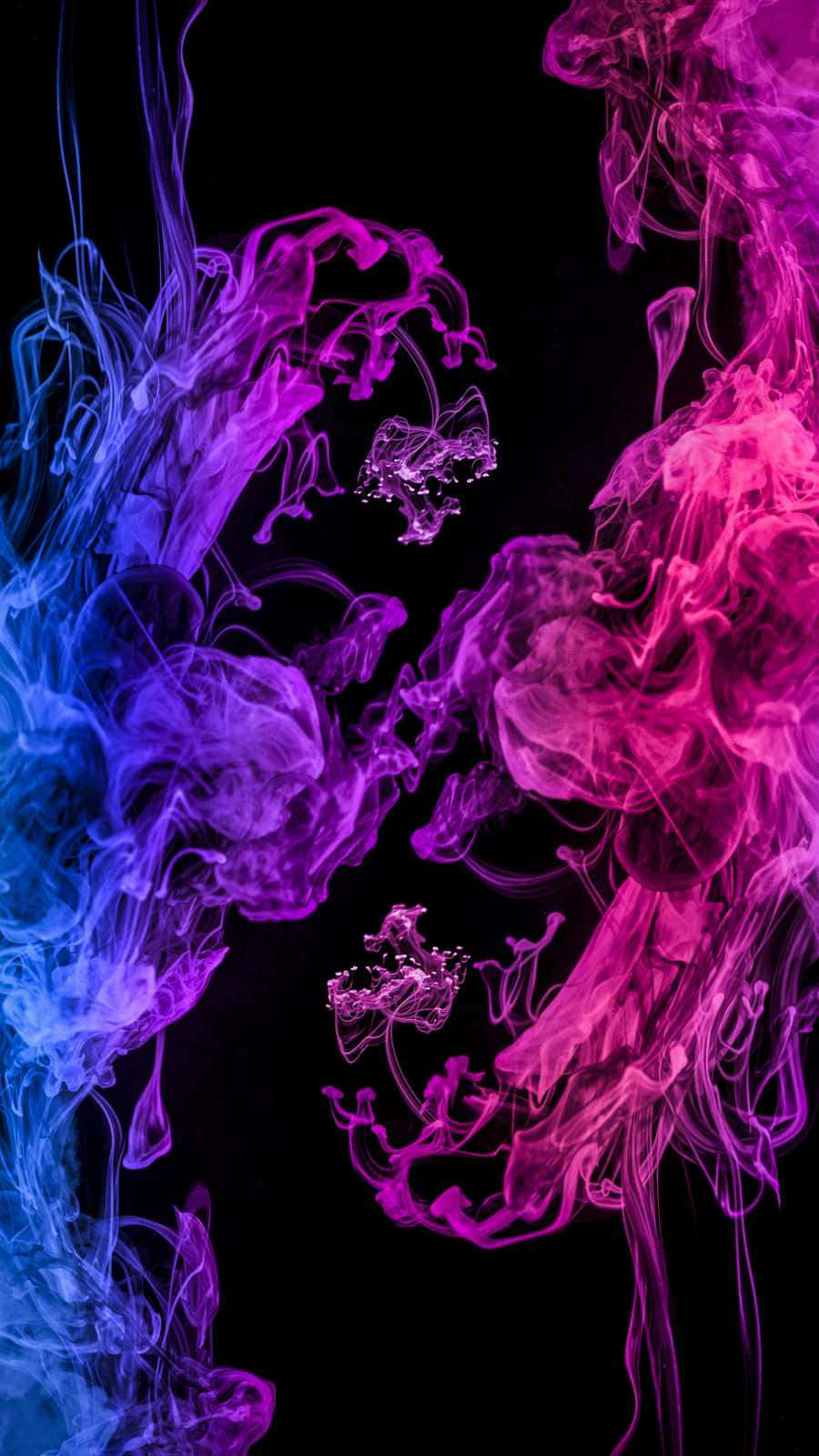 A Vibrant Display Of Color Billowing Into The Sky Background