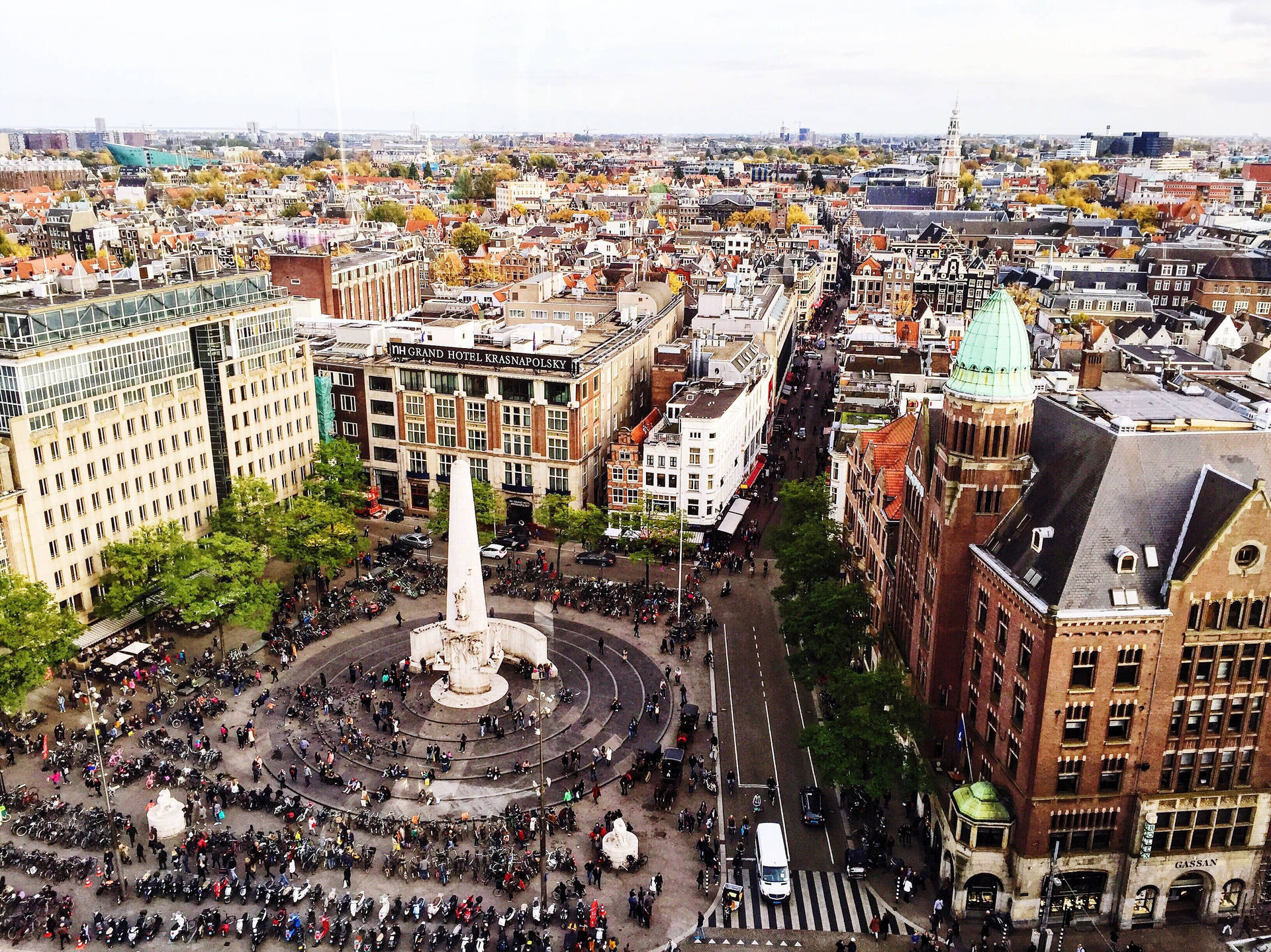 A Vibrant Gathering At Dam Square, Amsterdam Background