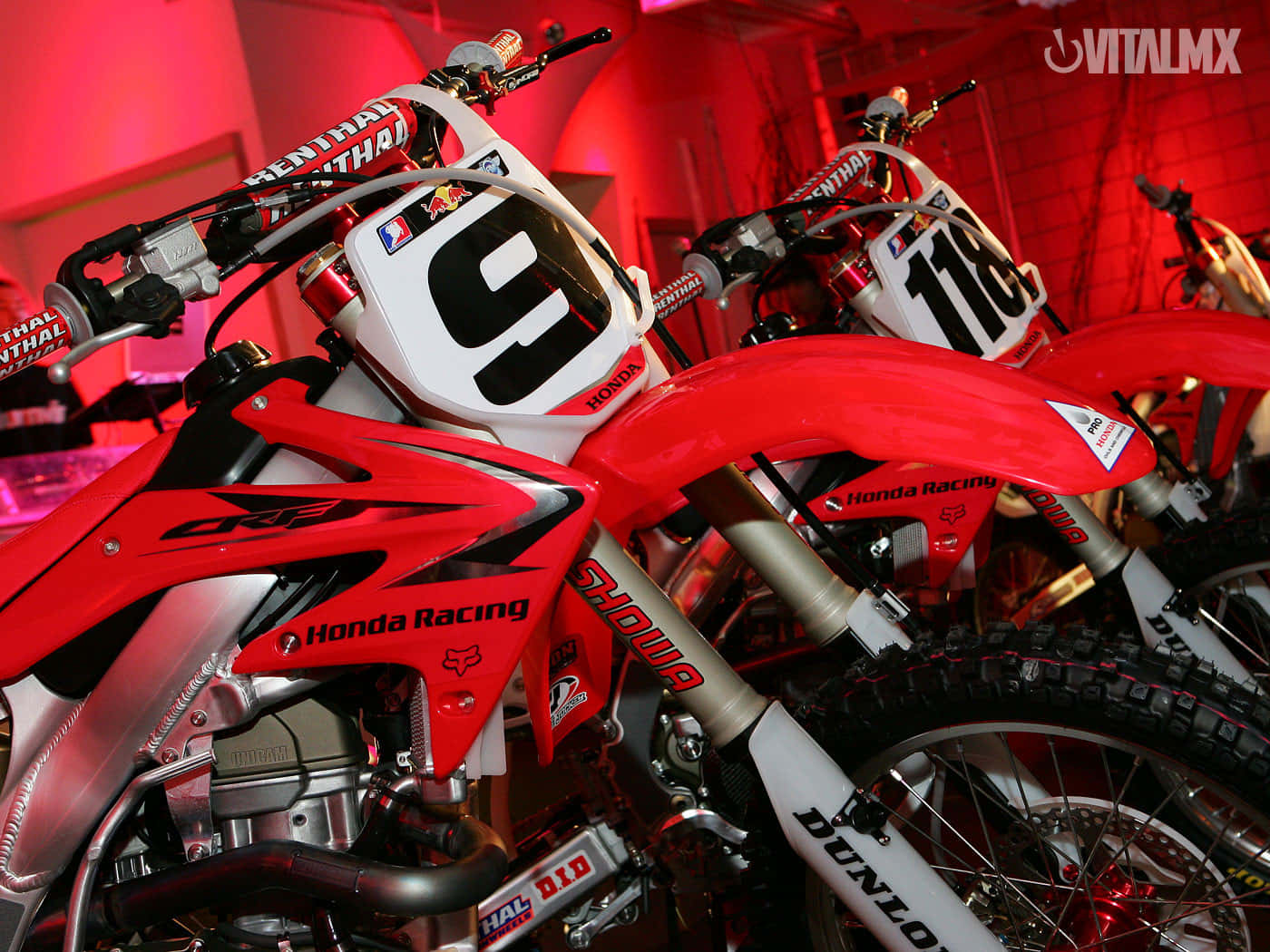 A Vibrant Red Vitalmax Motorcycle Background