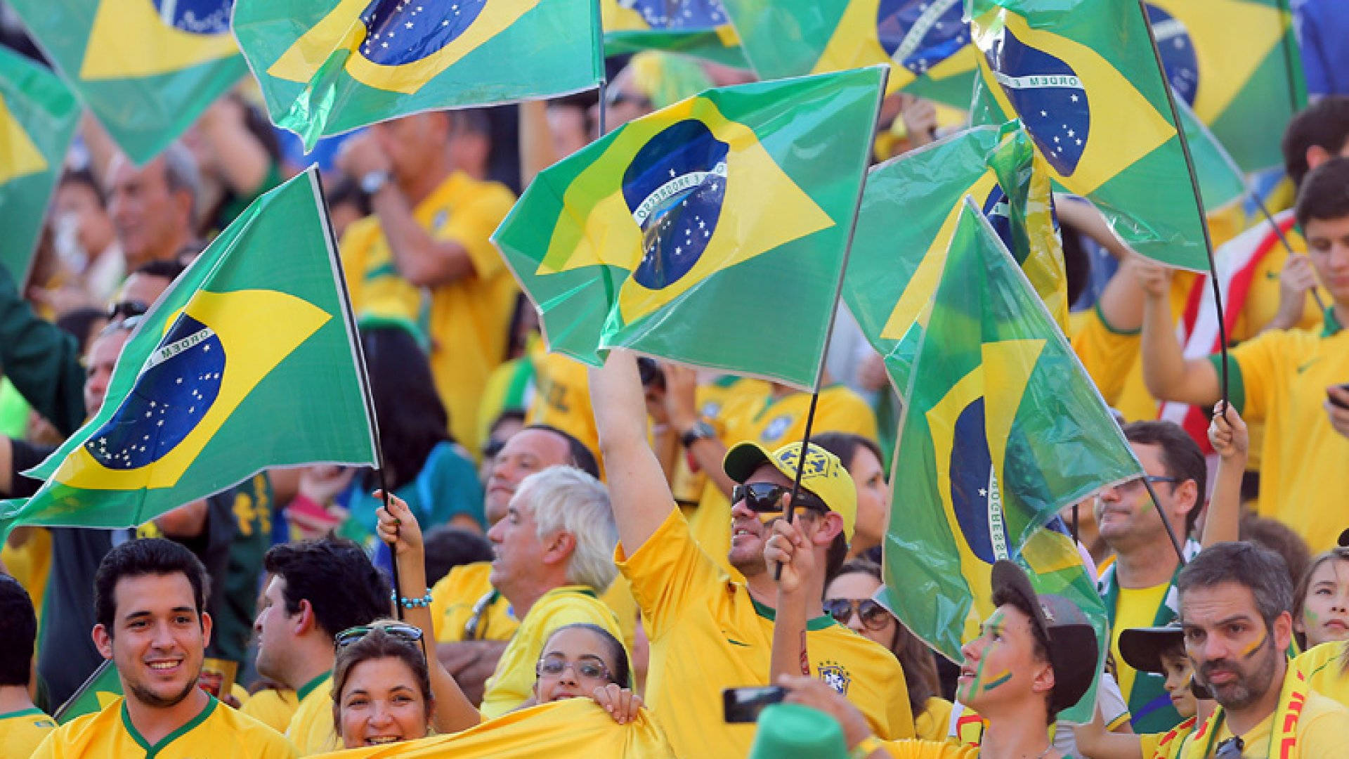 A Vibrant Waving Mini Brazil Flag Background