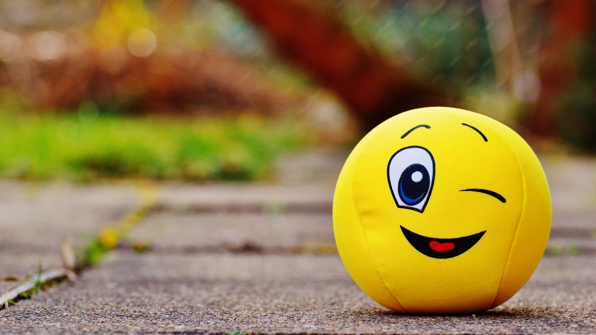 A Vibrant Yellow Smiling Ball Symbolizing Happiness And Positivity Background