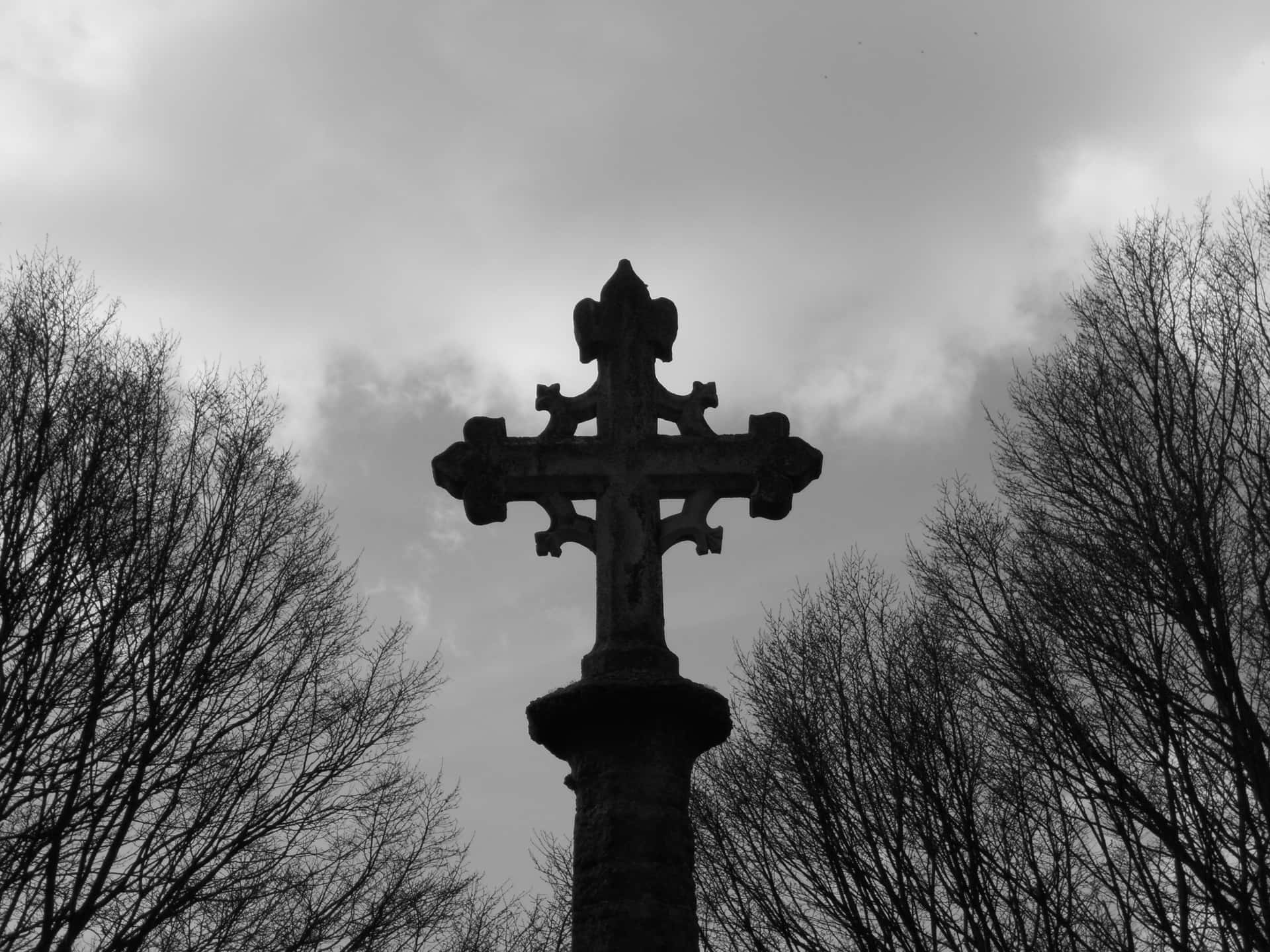 A View Of A Black Cross Against The Night Sky. Background