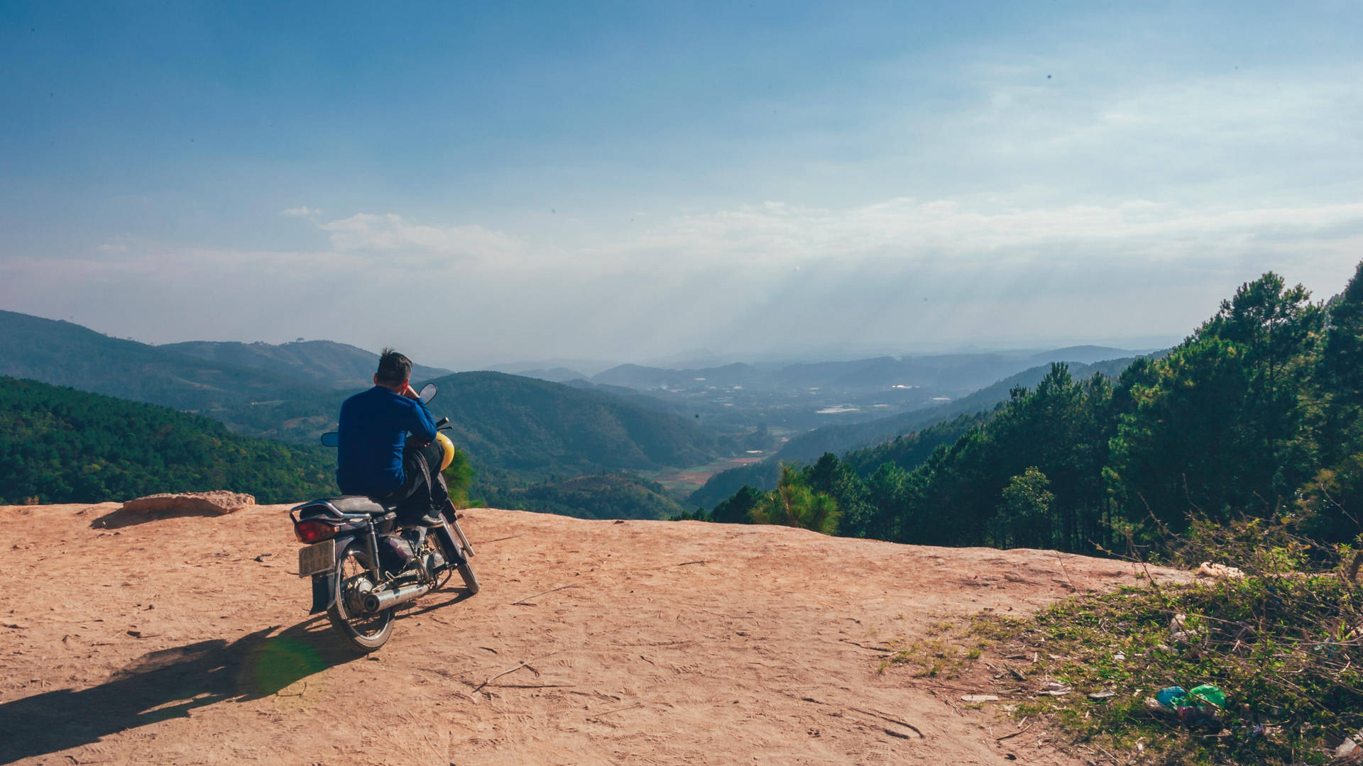 A View Of An Open Travel Laptop With An Expanse Of A City Mountain View In The Background Background