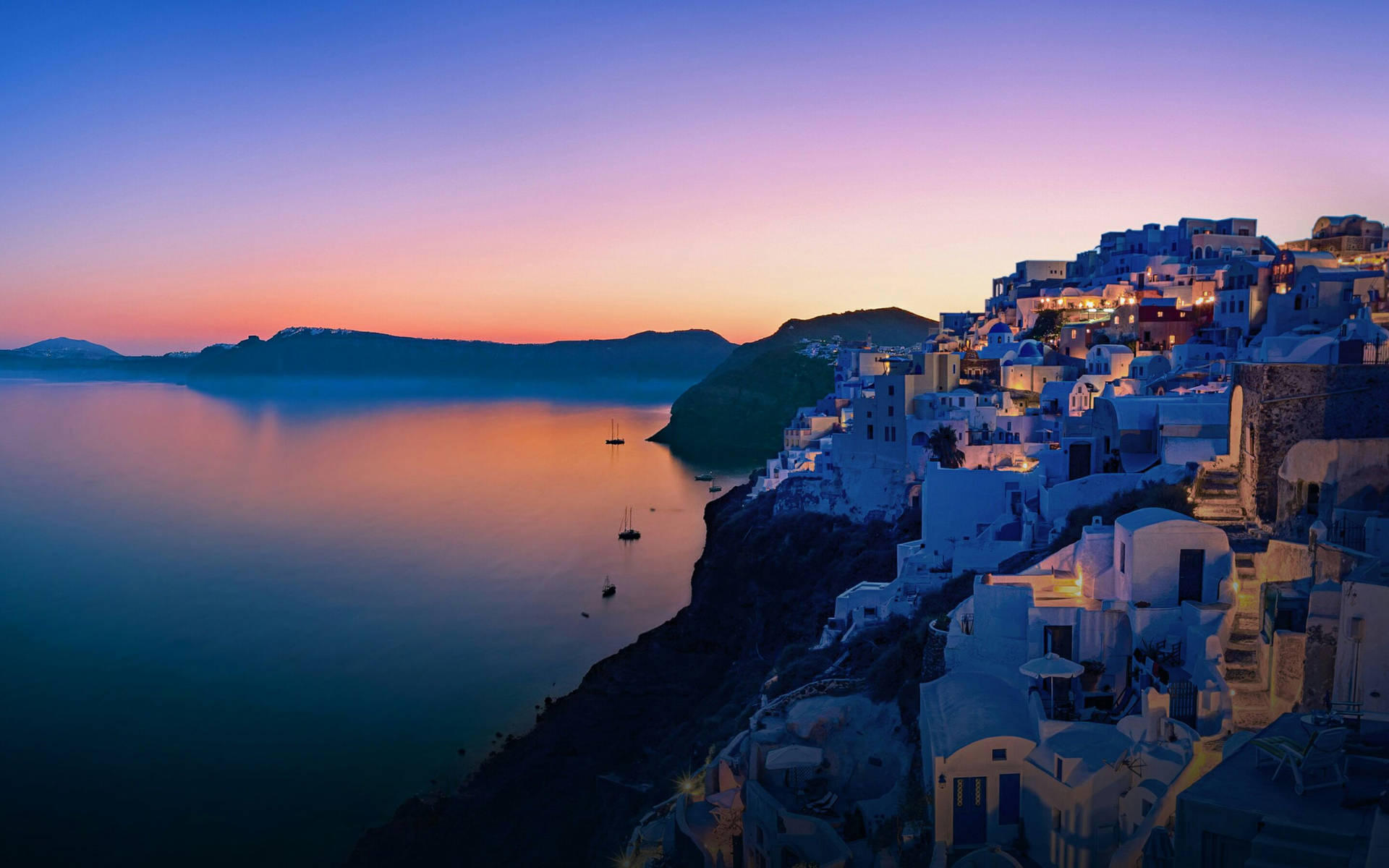A Village At Sunset In Santorini, Greece Background