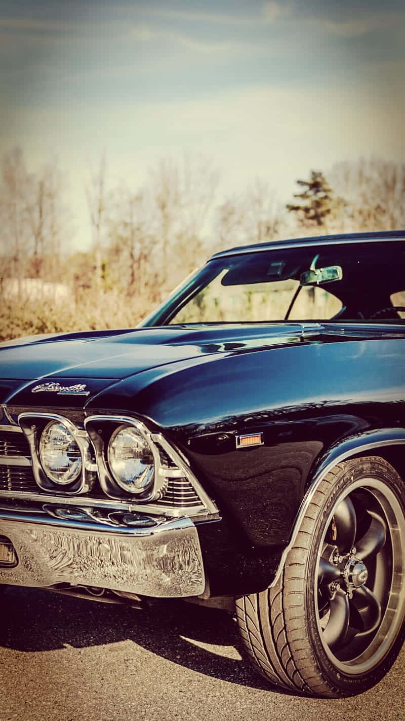 A Vintage Car Revs Its Engine Ready For Adventure Background