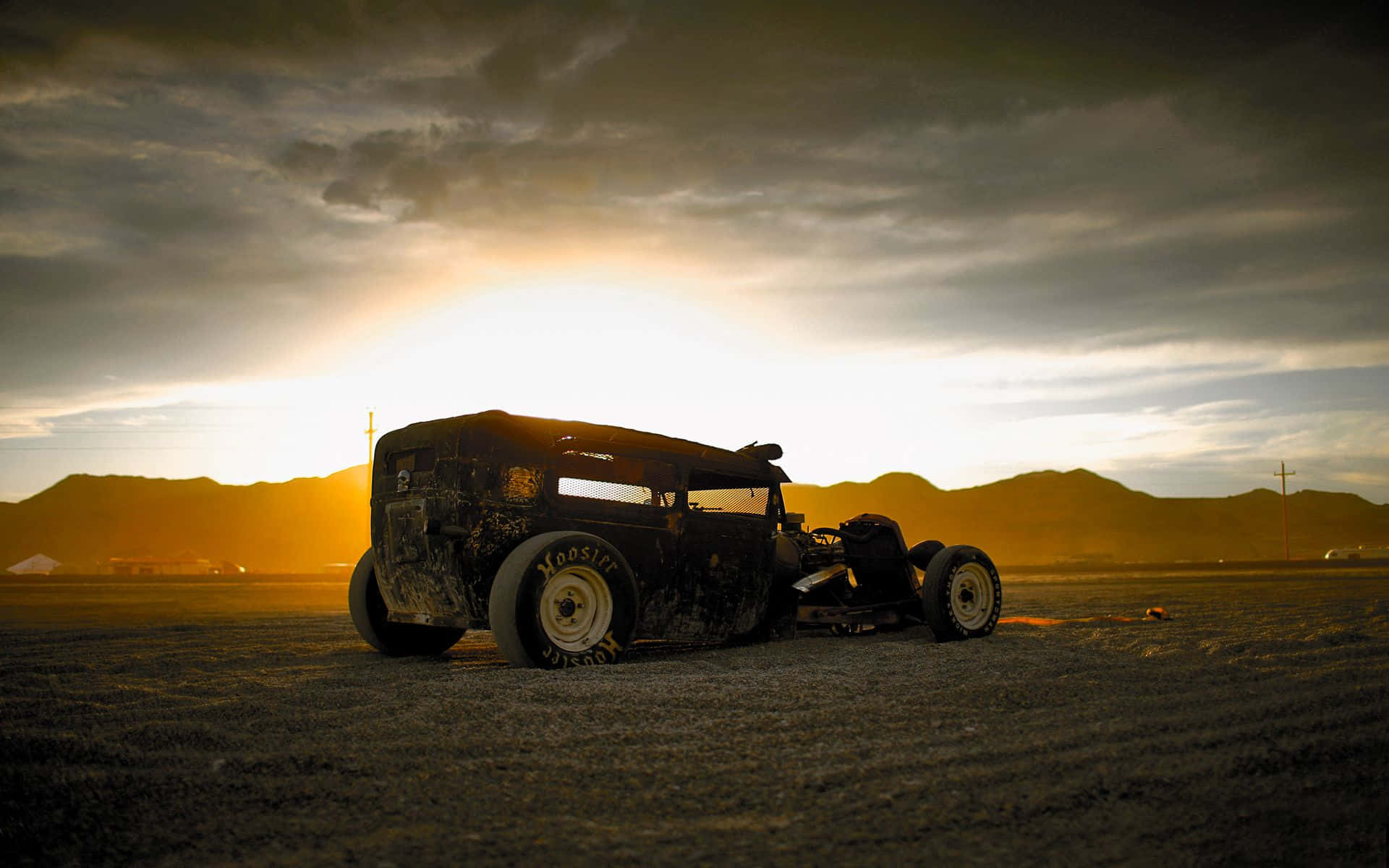 A Vintage Car Sitting In The Desert Background