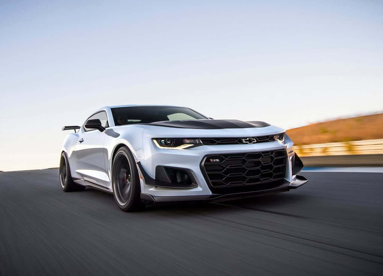 A Vintage, Cool Camaro Car Driving On The Open Road Background