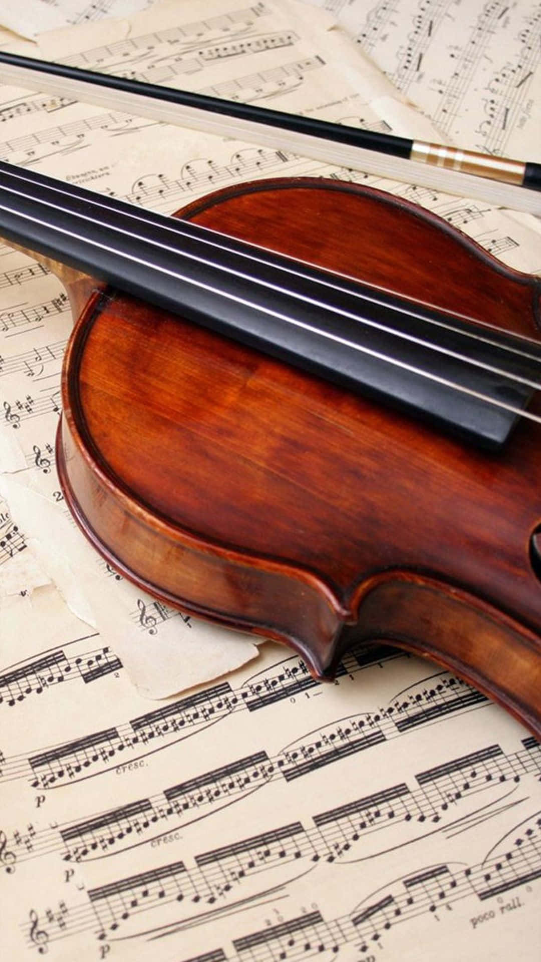 A Violin Resting On Music Sheets