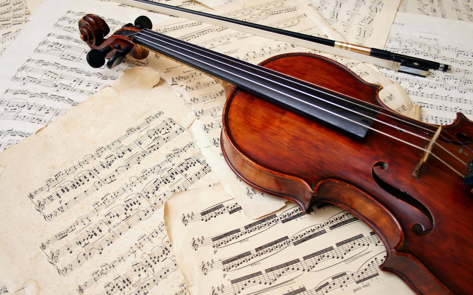 A Violin Resting On Music Sheets Background