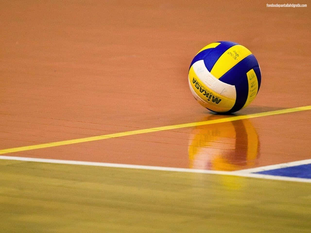 A Volleyball Ball Is Sitting On The Court Background