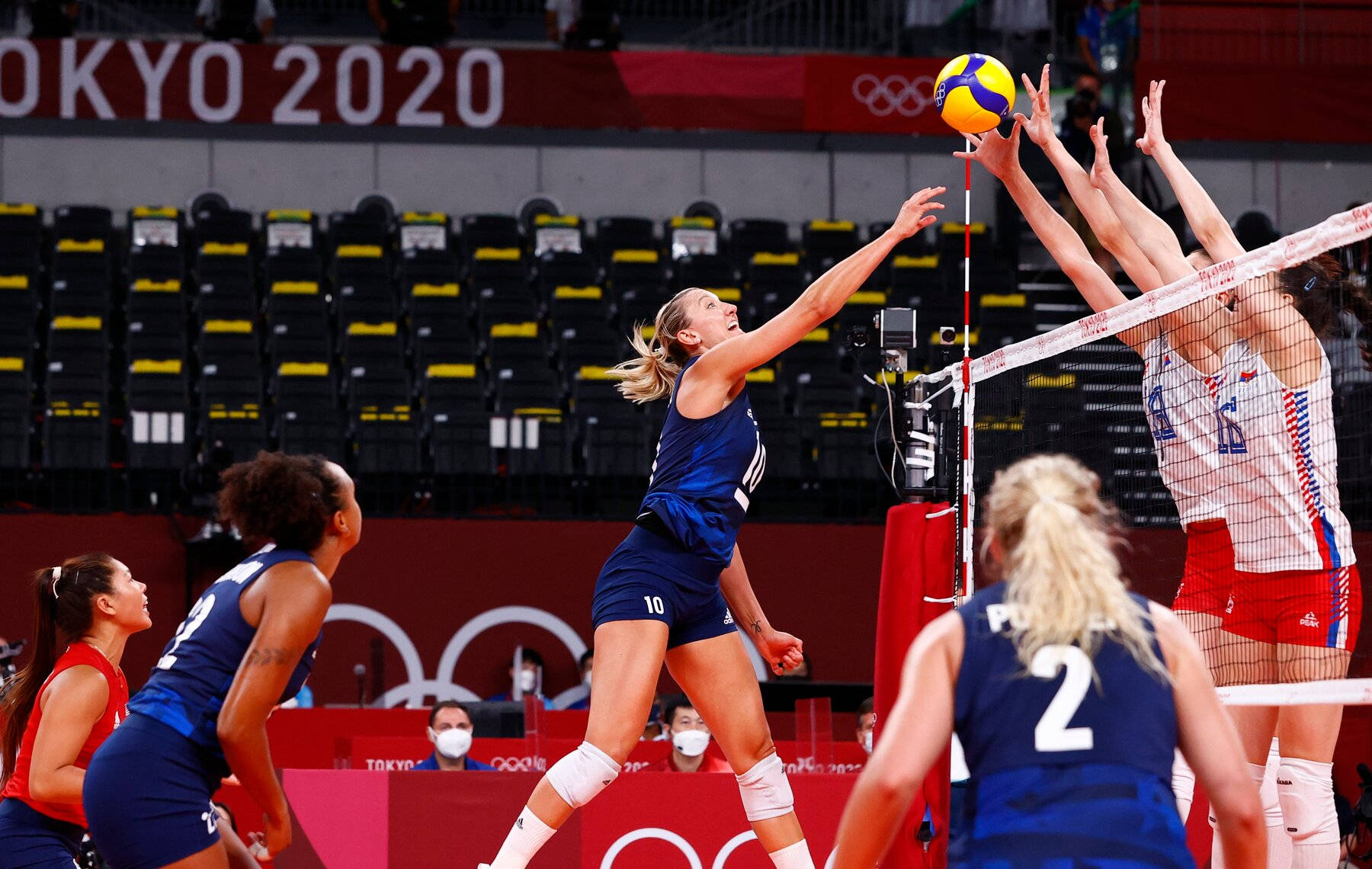 A Volleyball Team Is Playing In A Game Background