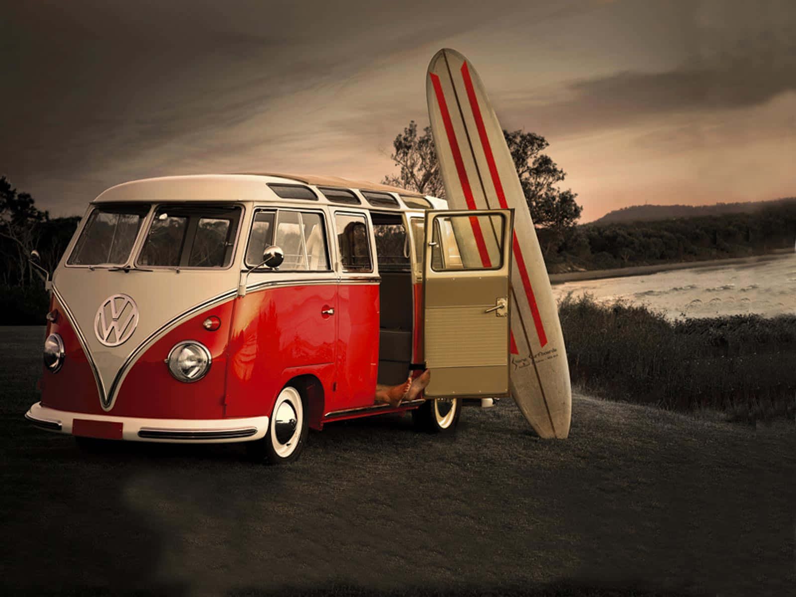 A Vw Bus With A Surfboard Background