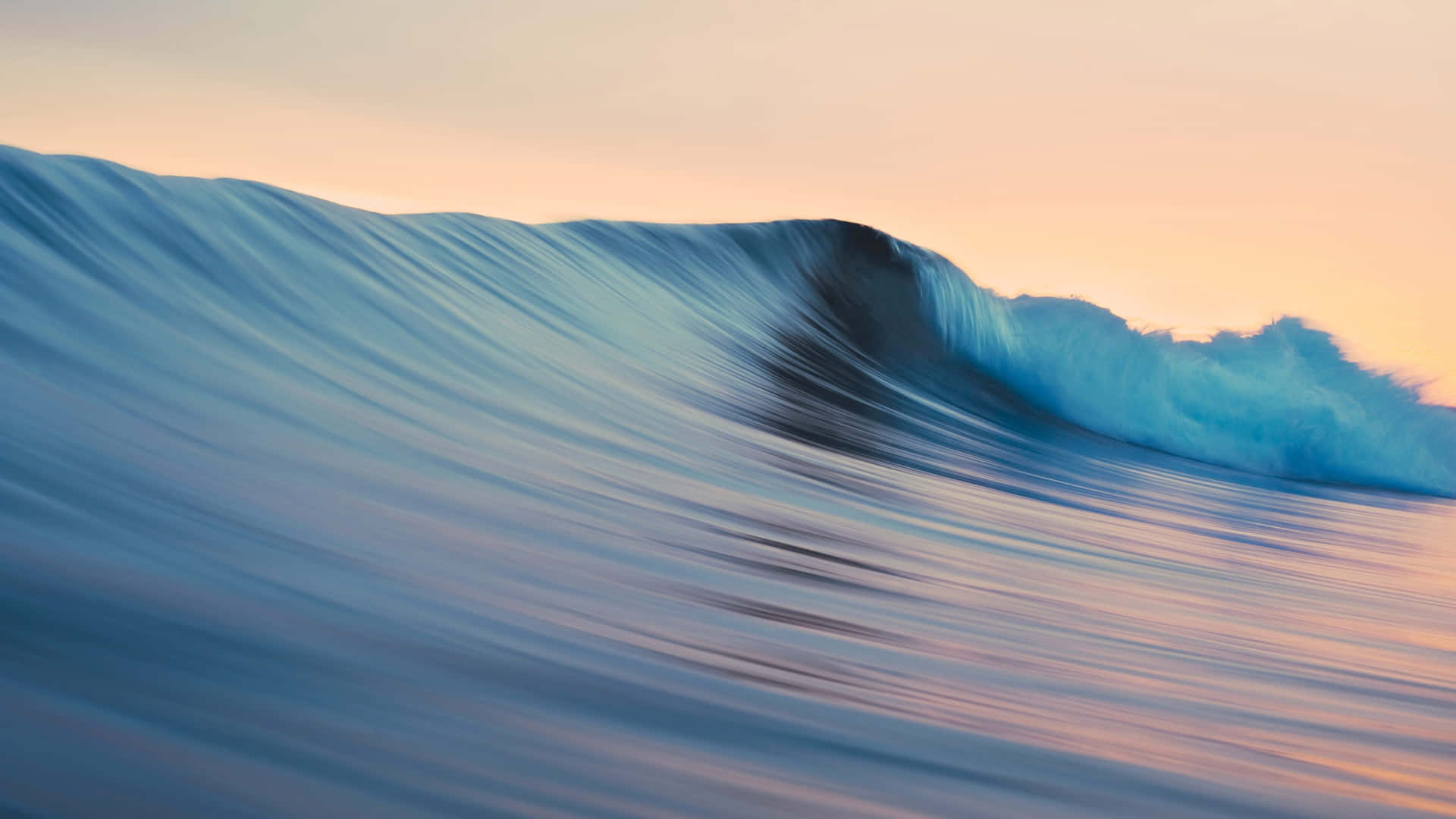 A Wave Is Breaking On The Ocean At Sunset Background
