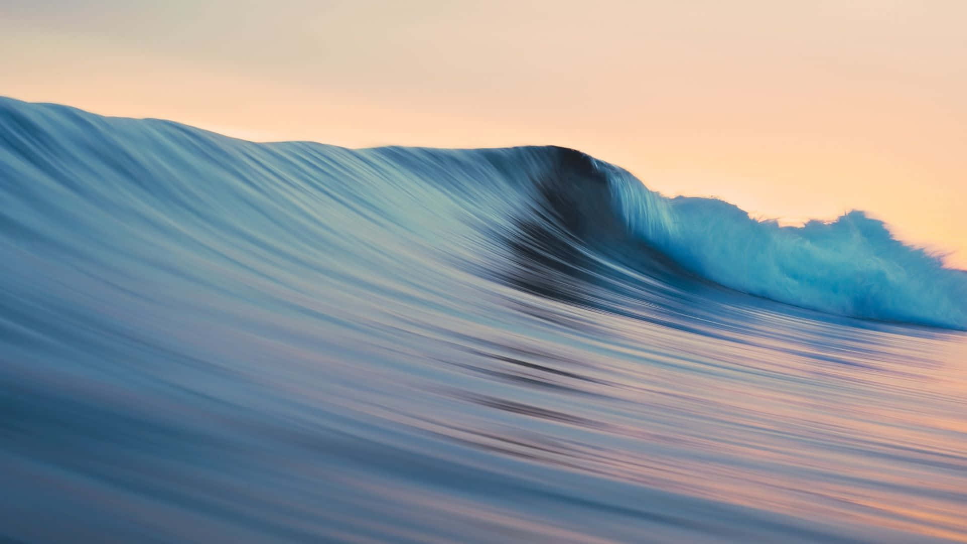 A Wave Is Breaking On The Ocean At Sunset Background