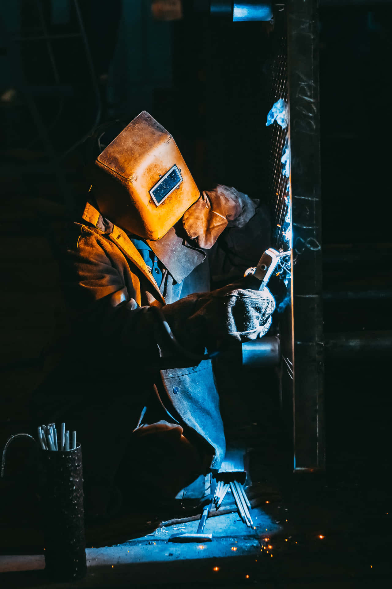 A Welder Working On A Metal Piece Background