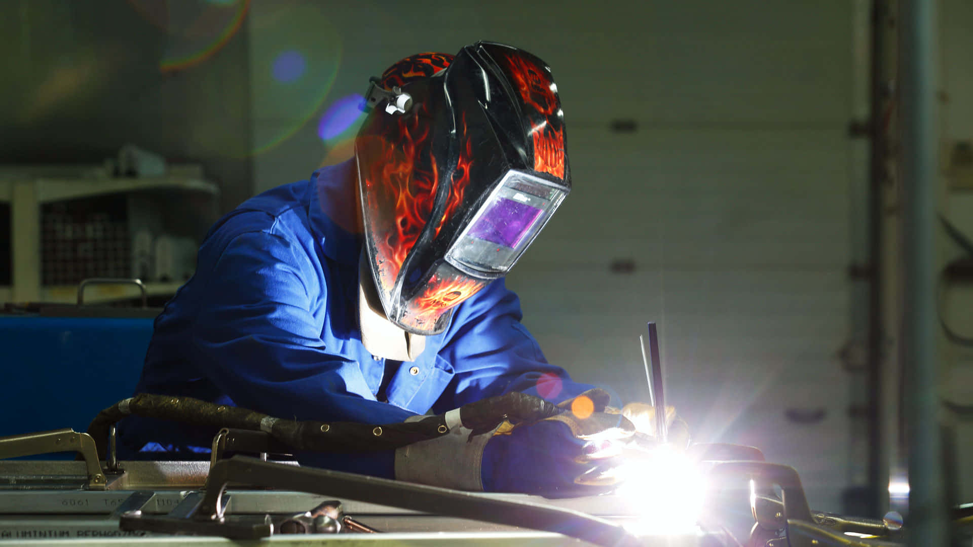 A Welder Working On A Metal Piece Background