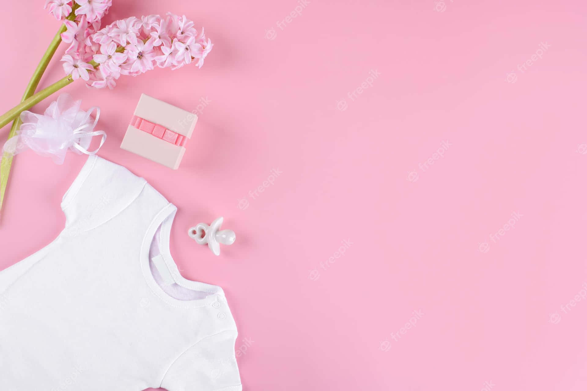 A White Baby Bodysuit On Pink Background With Flowers Background
