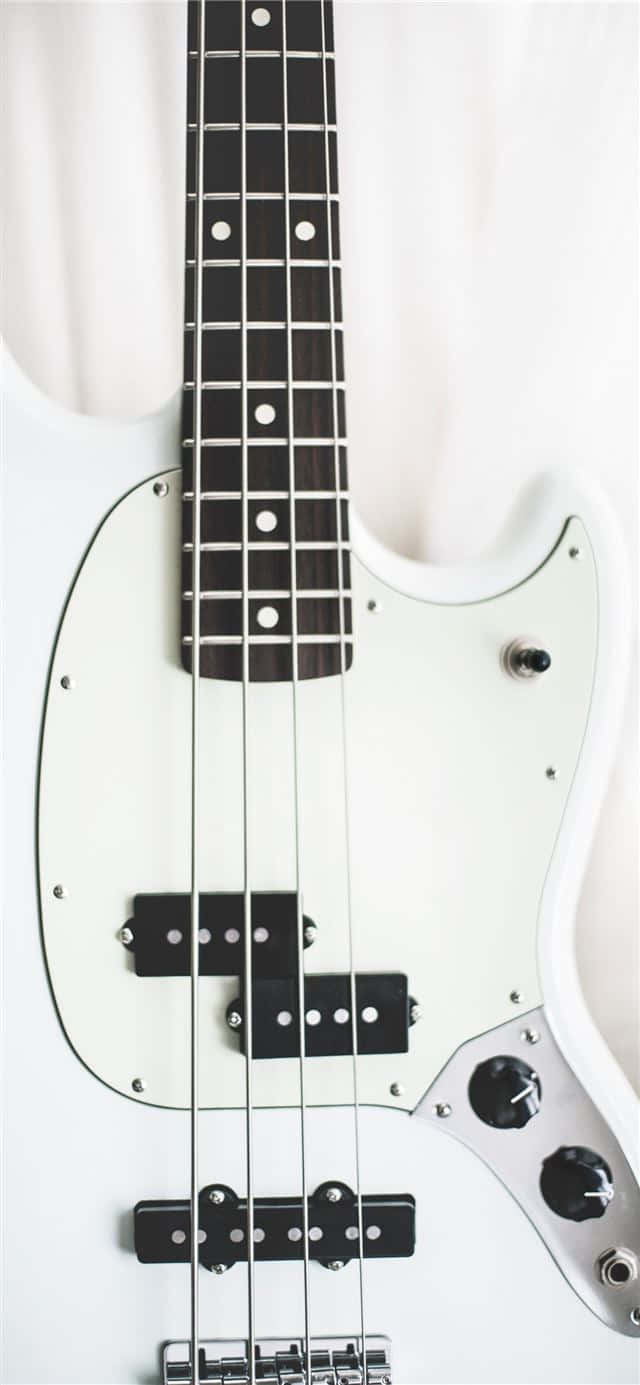 A White Bass Guitar With Black And White Strings