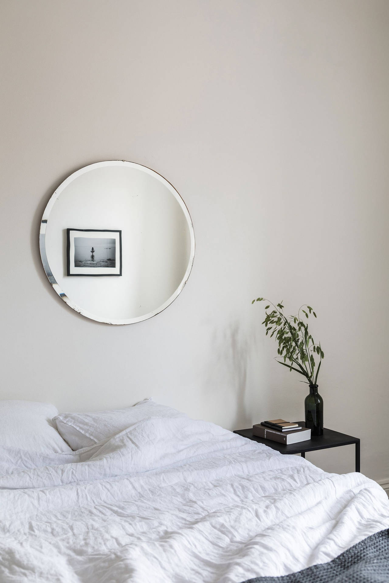 A White Bed With A Black Blanket