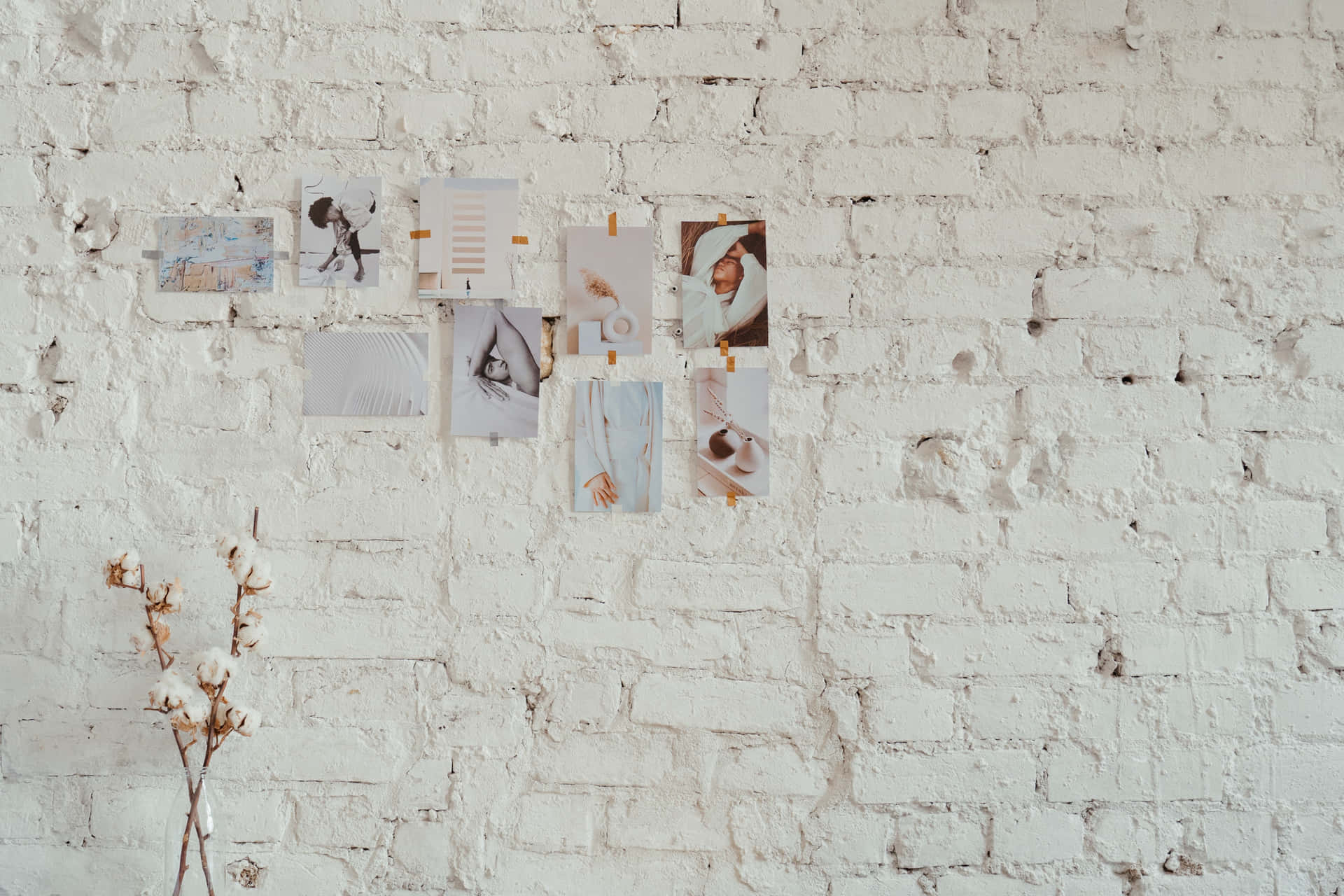 A White Brick Wall With A Vase And Some Photos Background