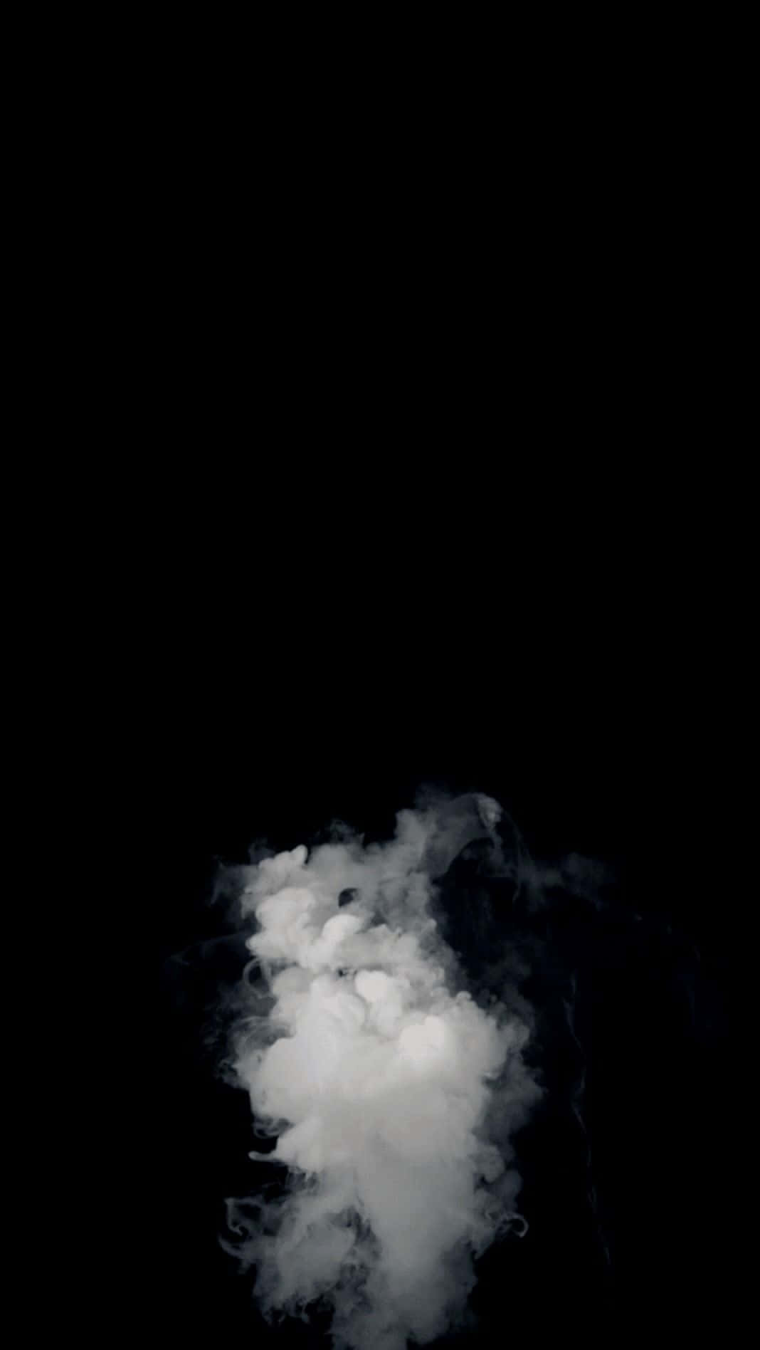 A White Cloud Floating In The Air On A Black Background Background