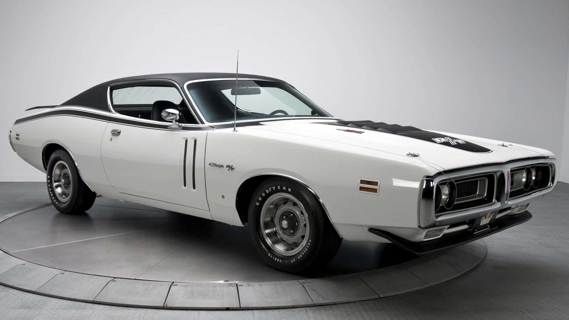 A White Dodge Charger Is On Display In A Room