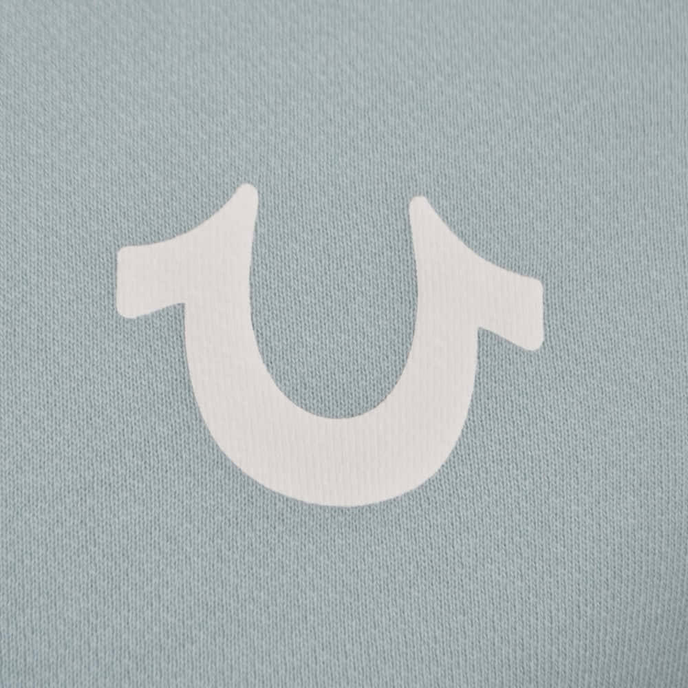 A White Horse Logo On A Blue Shirt Background