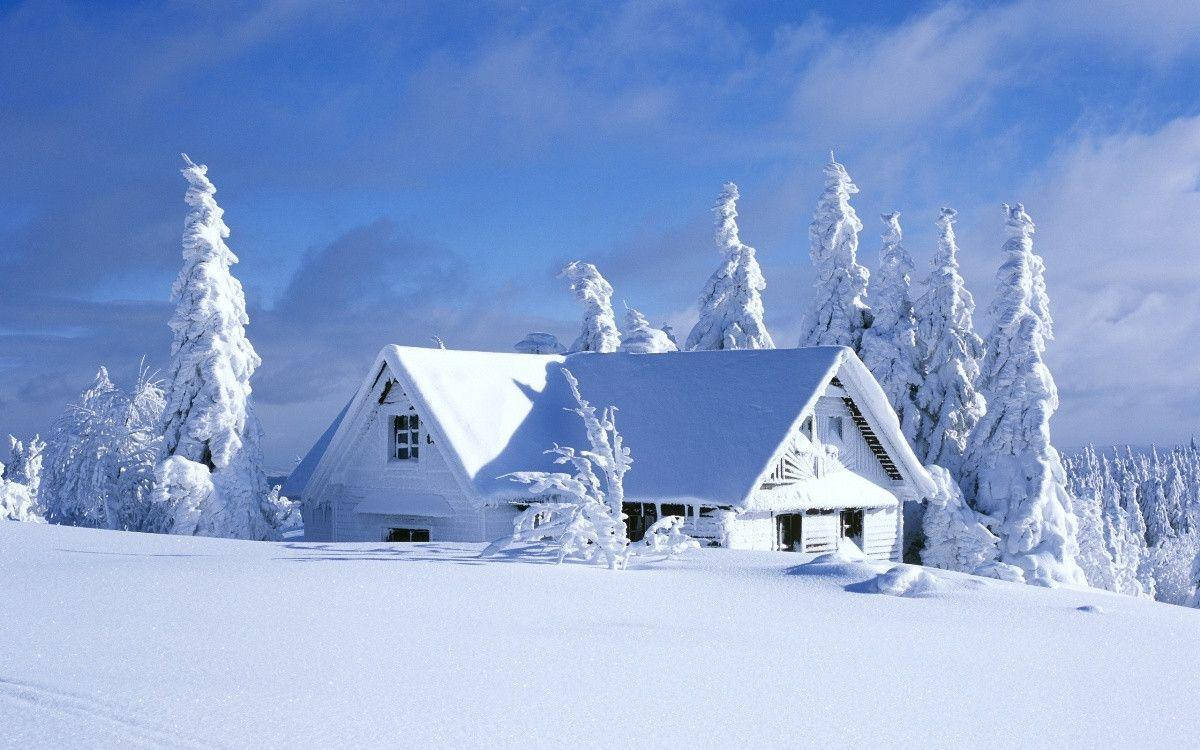 A White House On A Snow Covered Hill Background