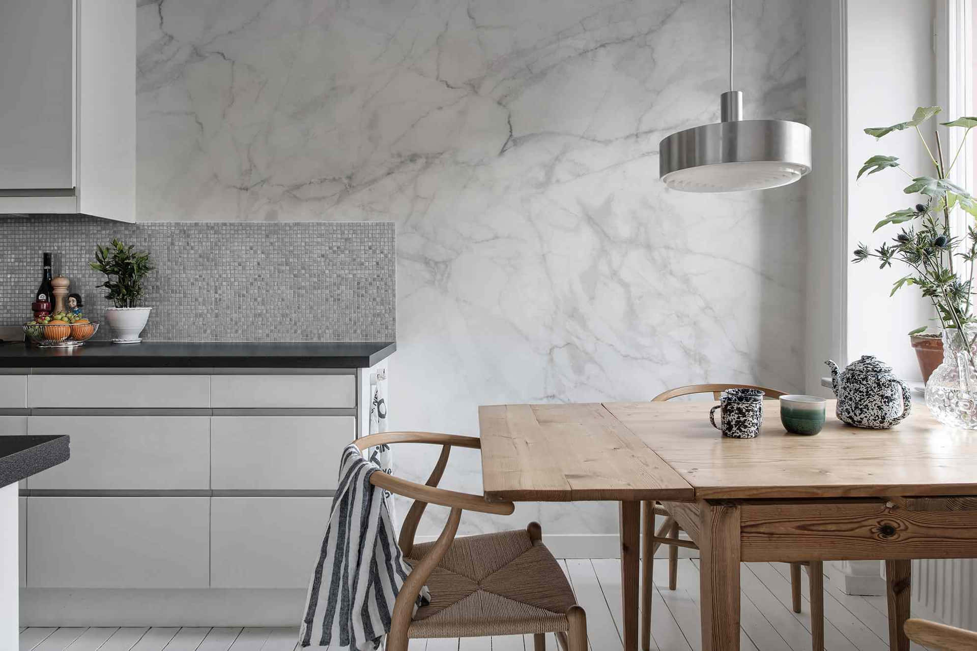 A White Kitchen With Marble Walls And Wooden Table Background