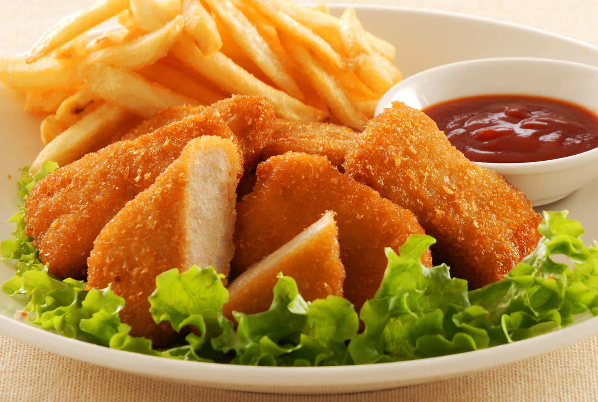 A White Plate With A Chicken And Fries