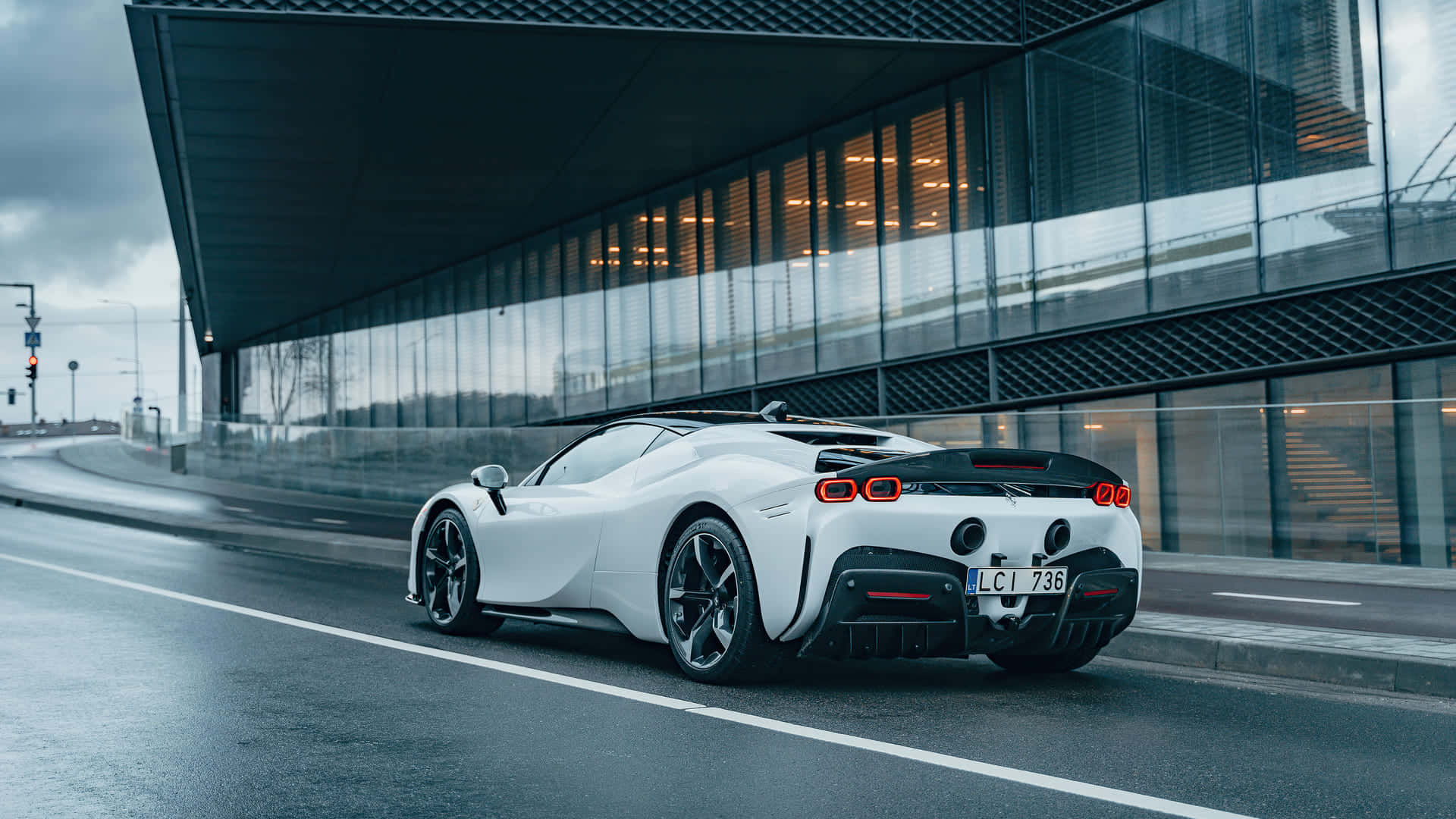 A White Sports Car Driving Down A Street Background